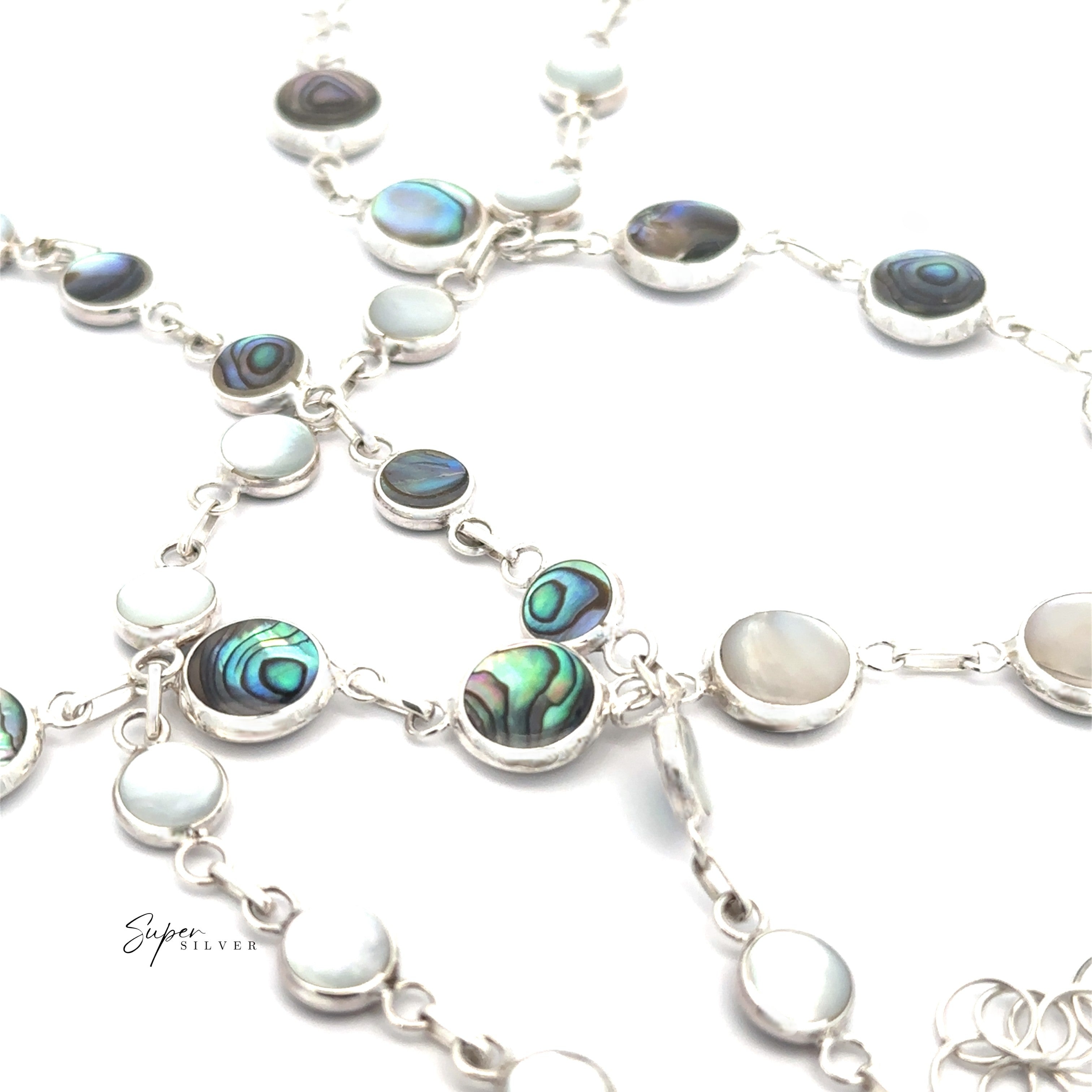 Close-up of the Reversible Round Inlay Stone Bracelet, featuring silver chain and Abalone and Mother of Pearl inlays, displayed on a white background.