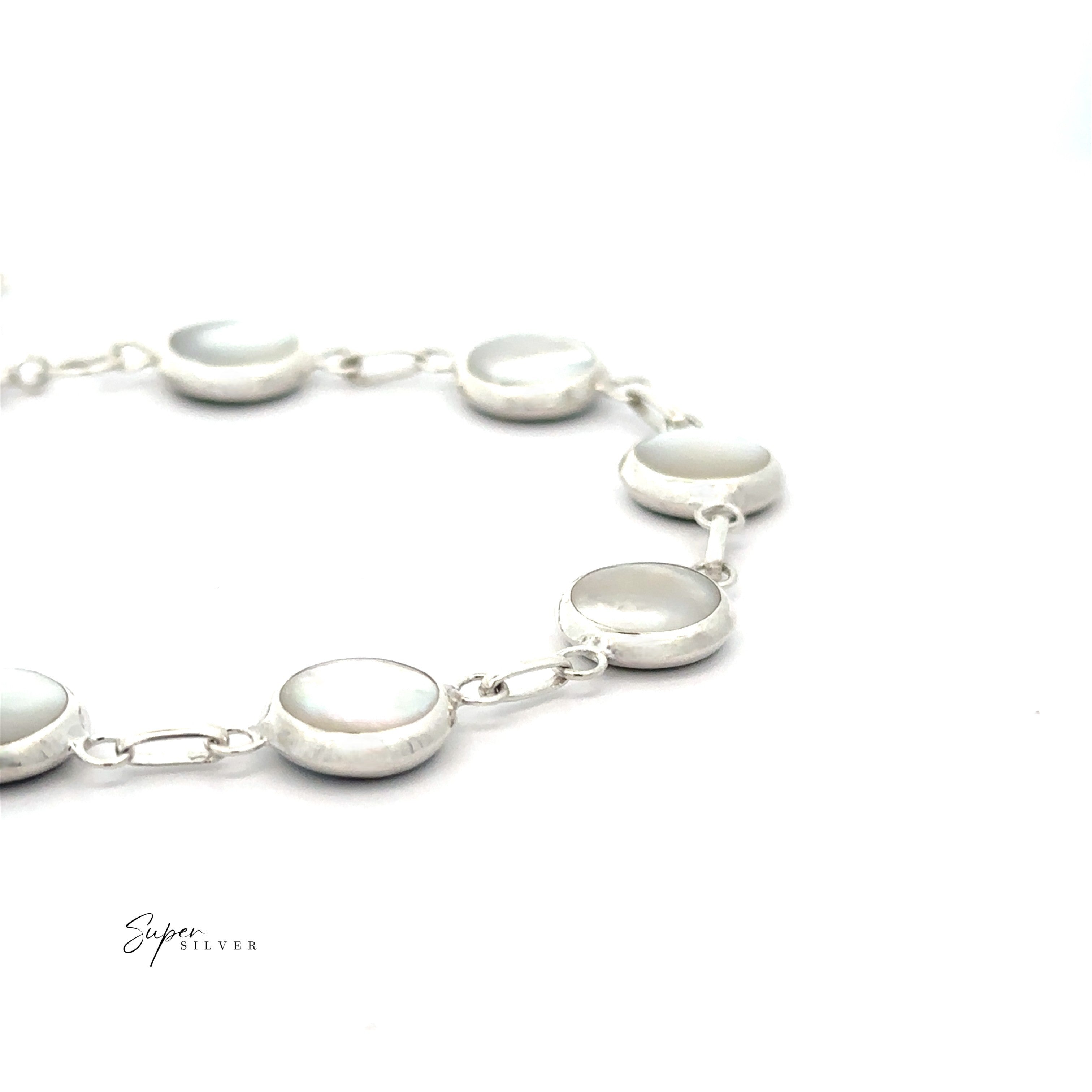 The Reversable Round Inlay Stone Bracelet features round, polished silver links and is displayed on a white background with the "Super Silver" logo in the lower left corner.