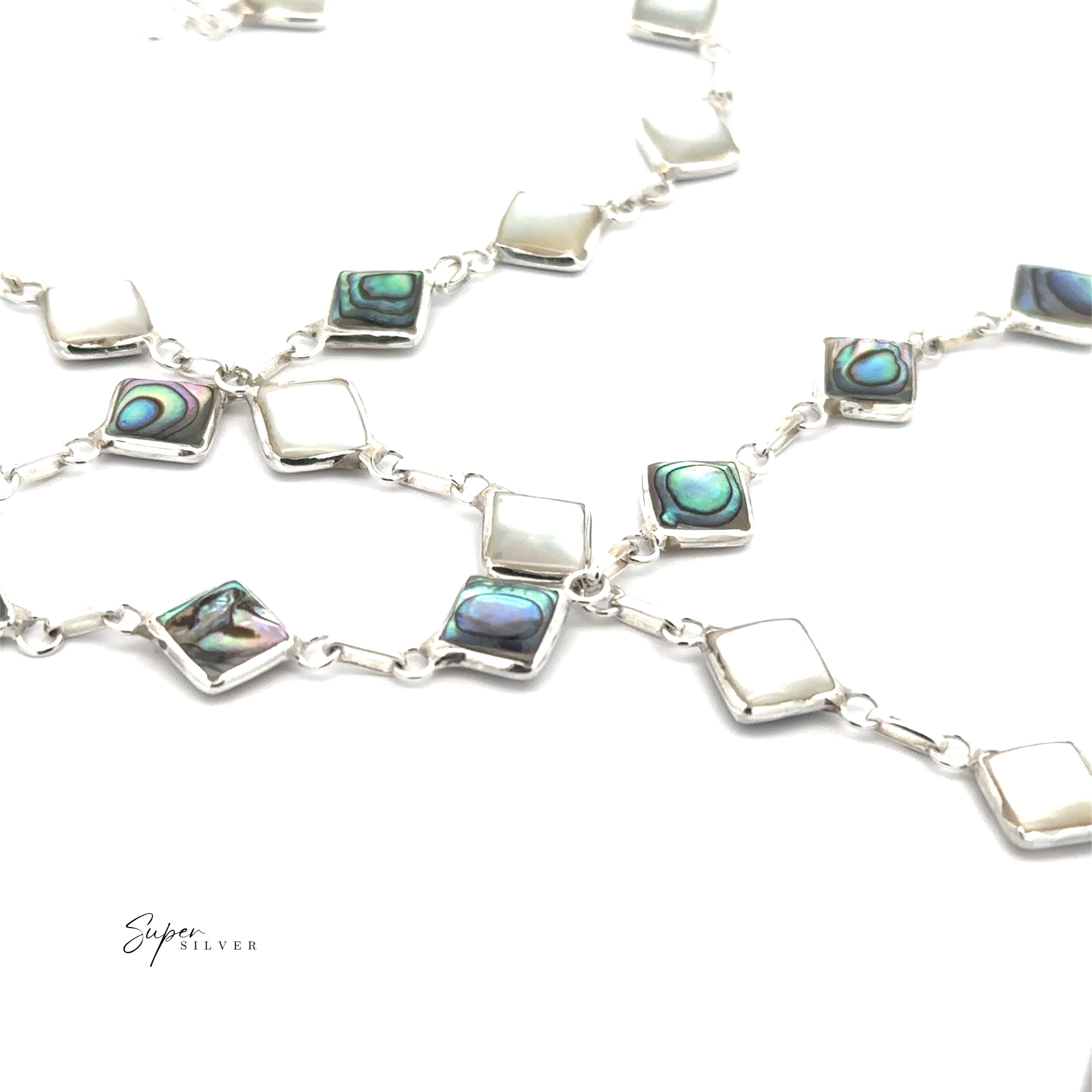 The Reversible Diamond Shaped Inlay Stone Bracelet features alternating abalone and white shell stones set in silver, arranged in a chain pattern—ideal for abalone jewelry lovers. Shown on a white background.