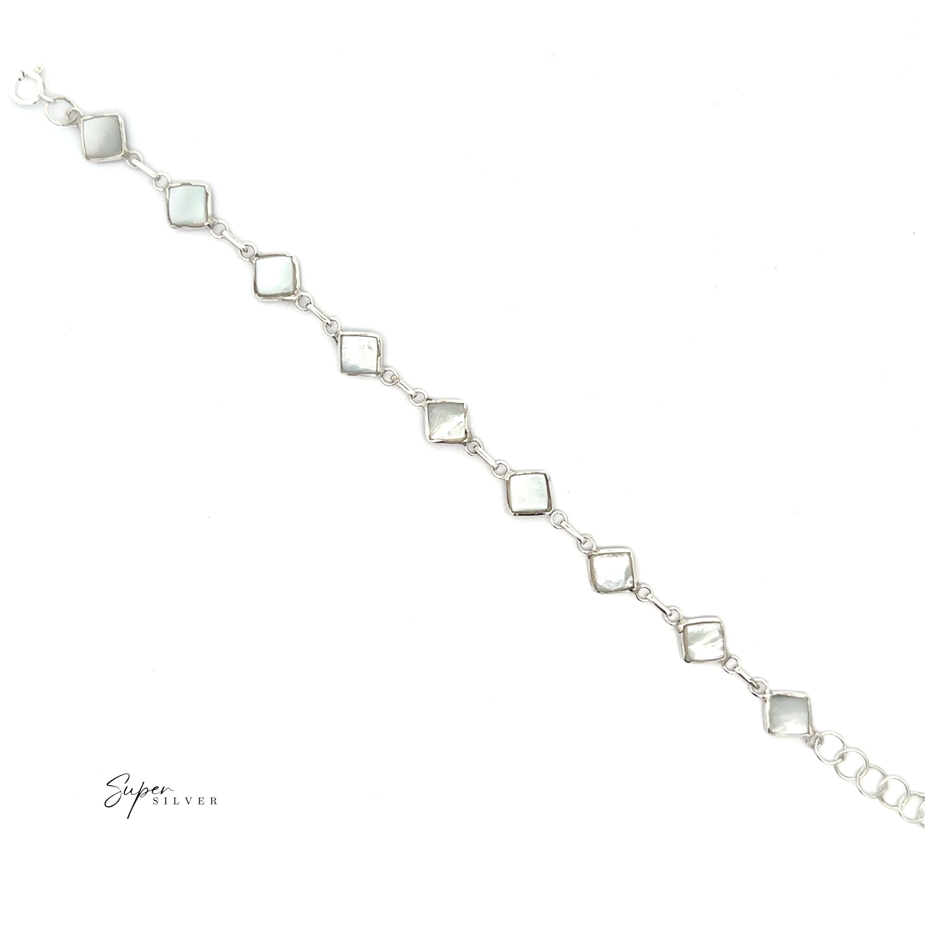 The Reversible Diamond Shaped Inlay Stone Bracelet, crafted from sterling silver, features square white mother-of-pearl links and is displayed diagonally on a white background.