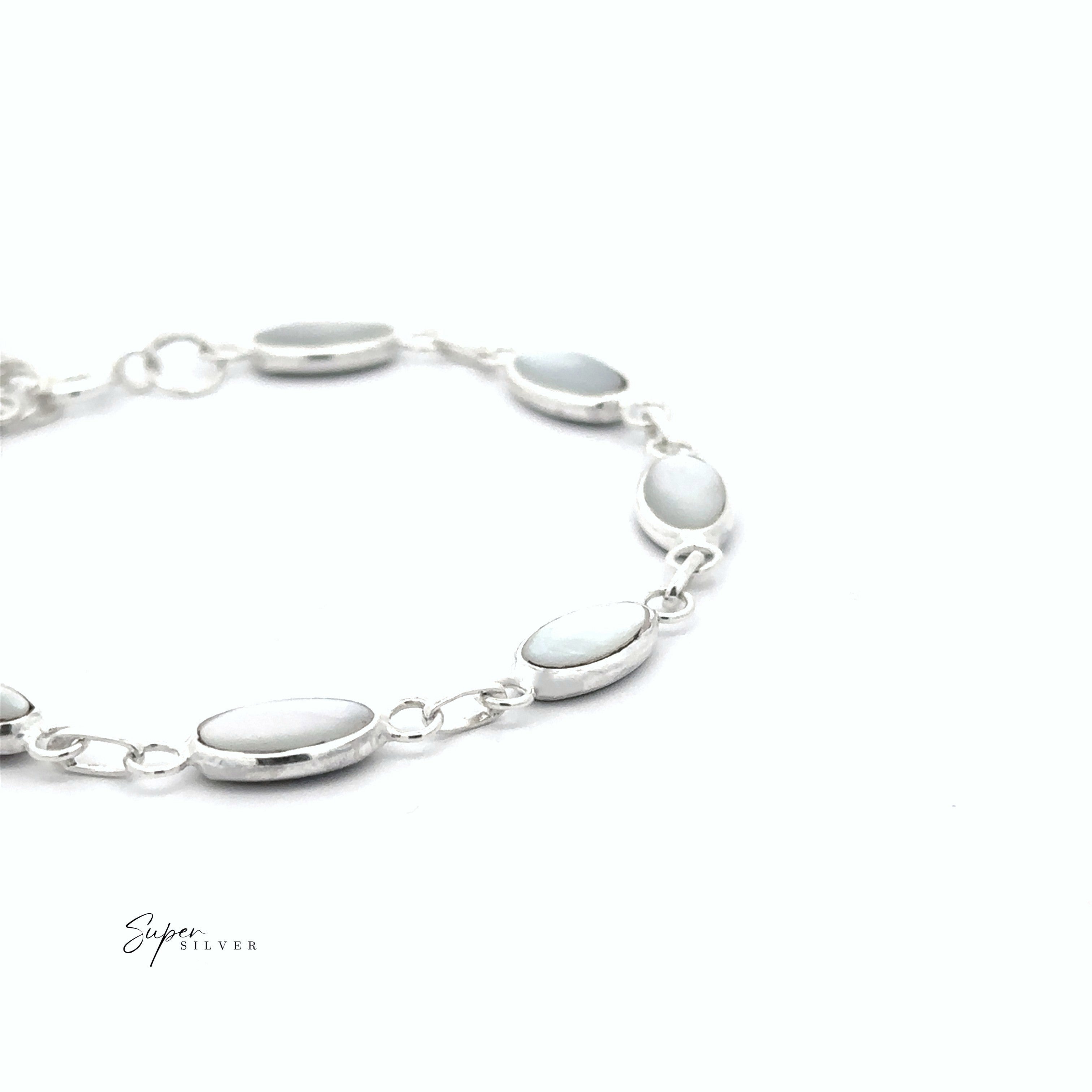 A Reversible Oval Shaped Inlay Stone Bracelet with silver links and mother of pearl stones is displayed on a plain white background. The text "Super Silver" appears in the lower left corner.