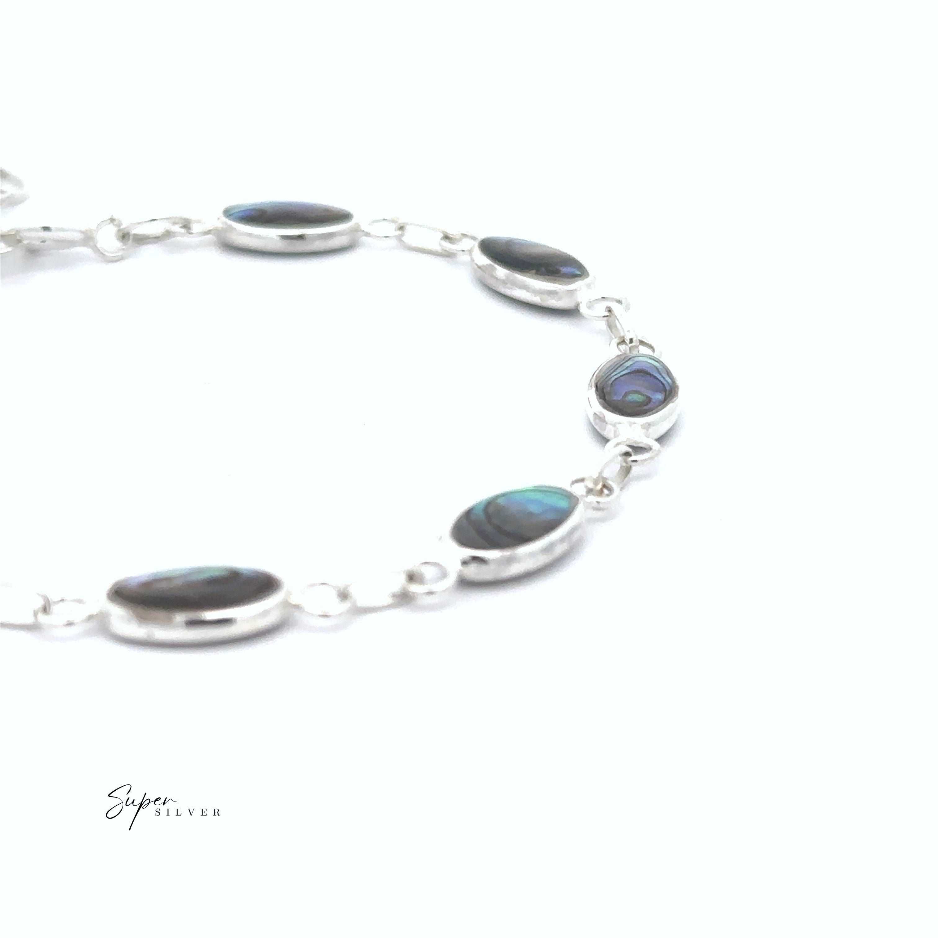 The Reversible Oval Shaped Inlay Stone Bracelet, featuring silver oval links with inlay stone details, is displayed on a white background.