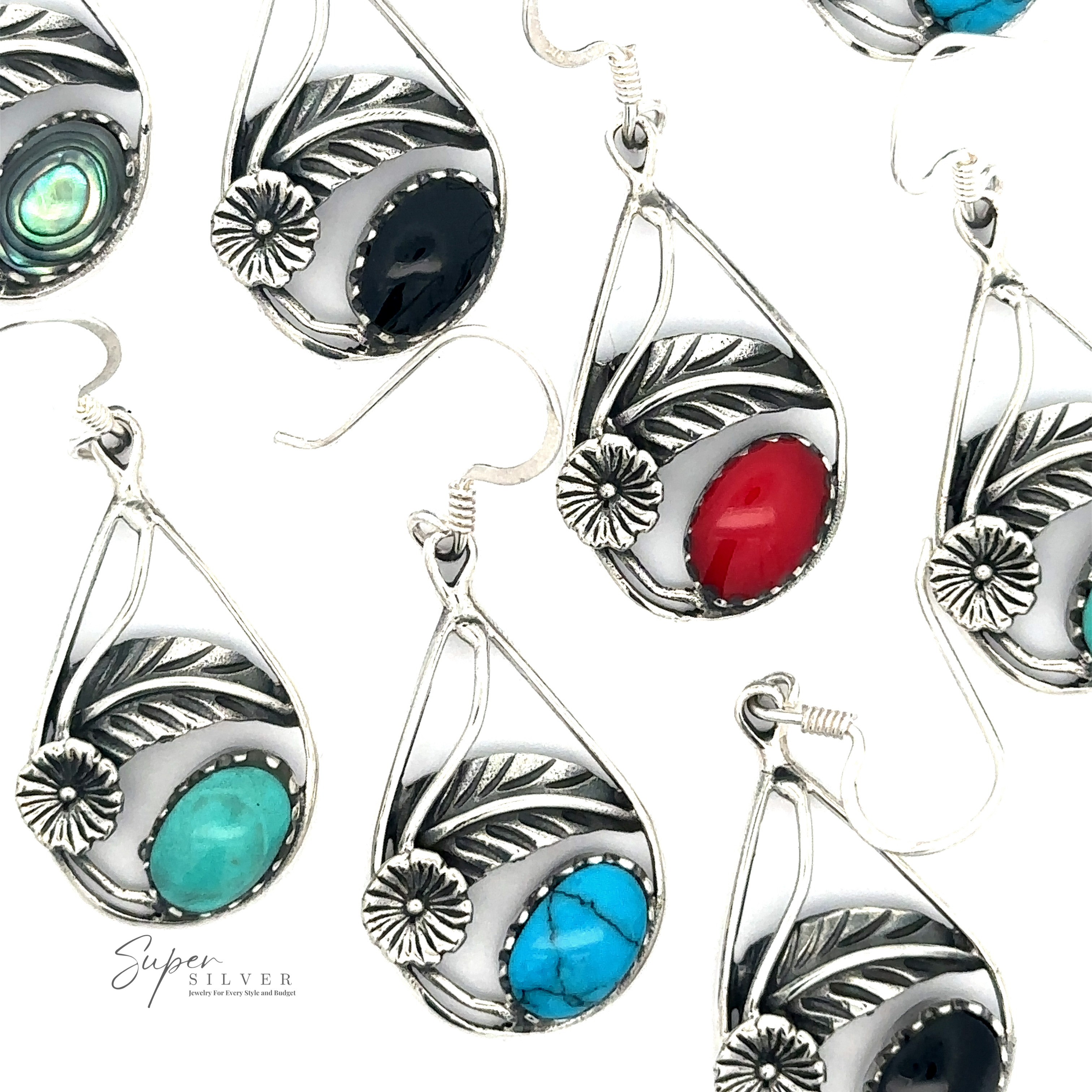A collection of ornate Inlaid Teardrop Earrings With Floral Setting with intricate sterling silver designs and various colored gemstones, including black, red, turquoise, and green.