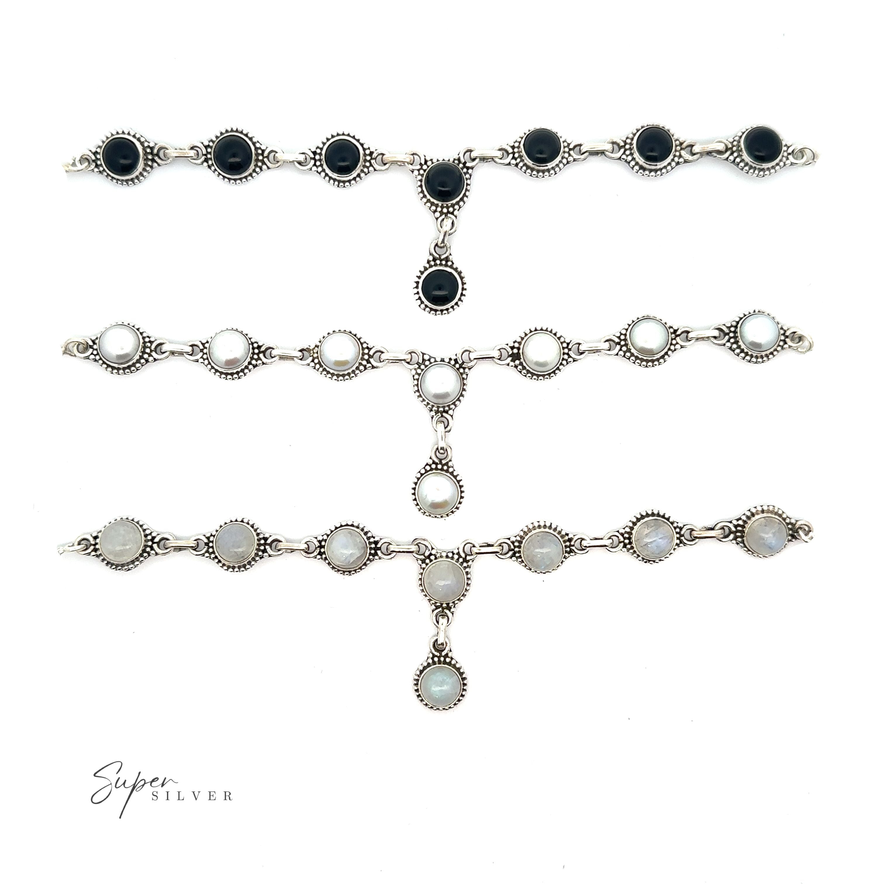 Three Round Gemstone Y Necklaces with Ball Border are displayed horizontally on a white background, embodying bohemian style jewelry. The first necklace features black stones, the second showcases white stones, and the third has gray stones.