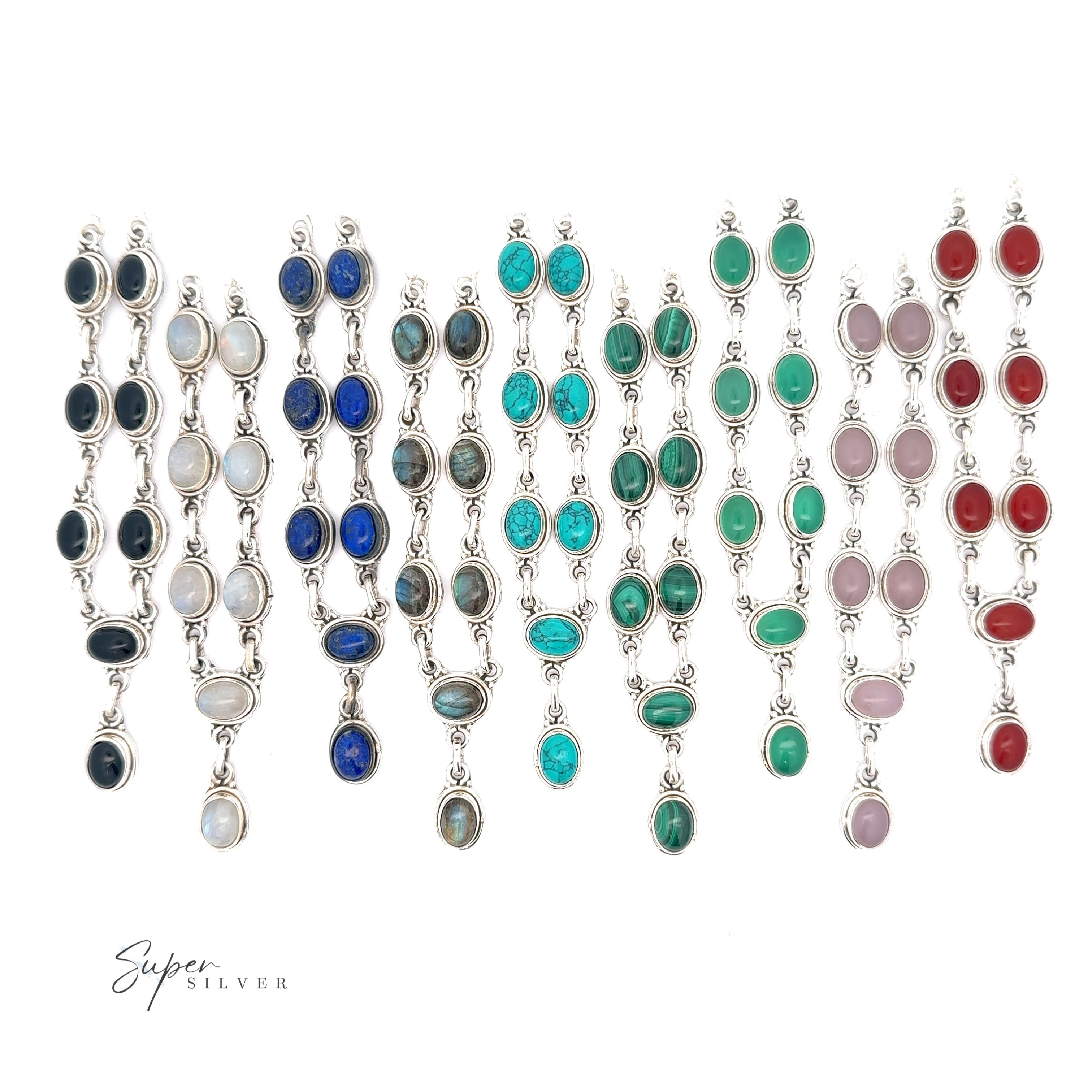 A display of multiple pairs of Simple Oval Y Necklace with Gemstones featuring various colored oval gemstones set in silver, exuding bohemian charm. Arranged in neat rows on a white background with the text "Super Silver" in the corner.