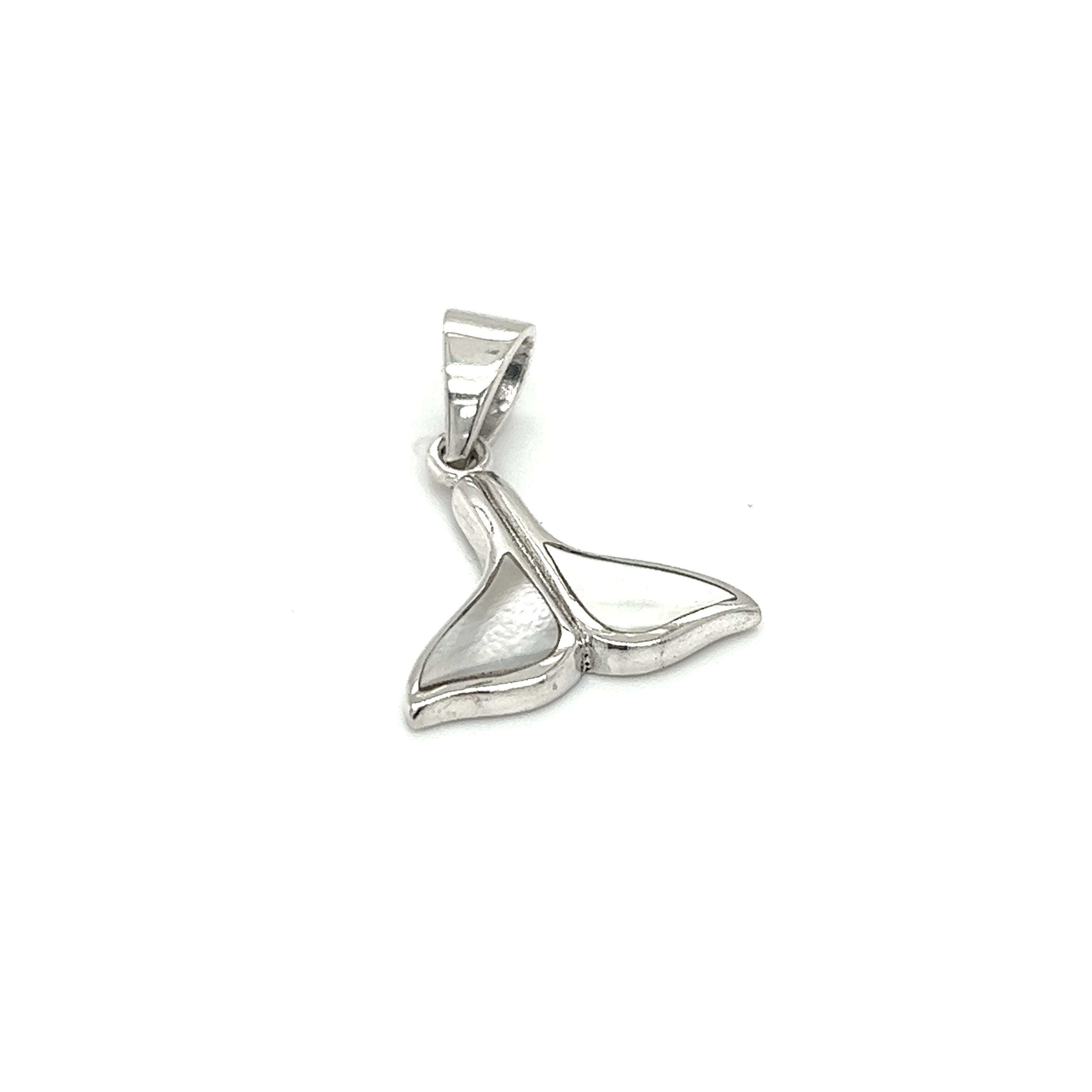 A Simple Whale Tail Pendant with Inlay Stones on a white background, representing ocean conservation by Super Silver.