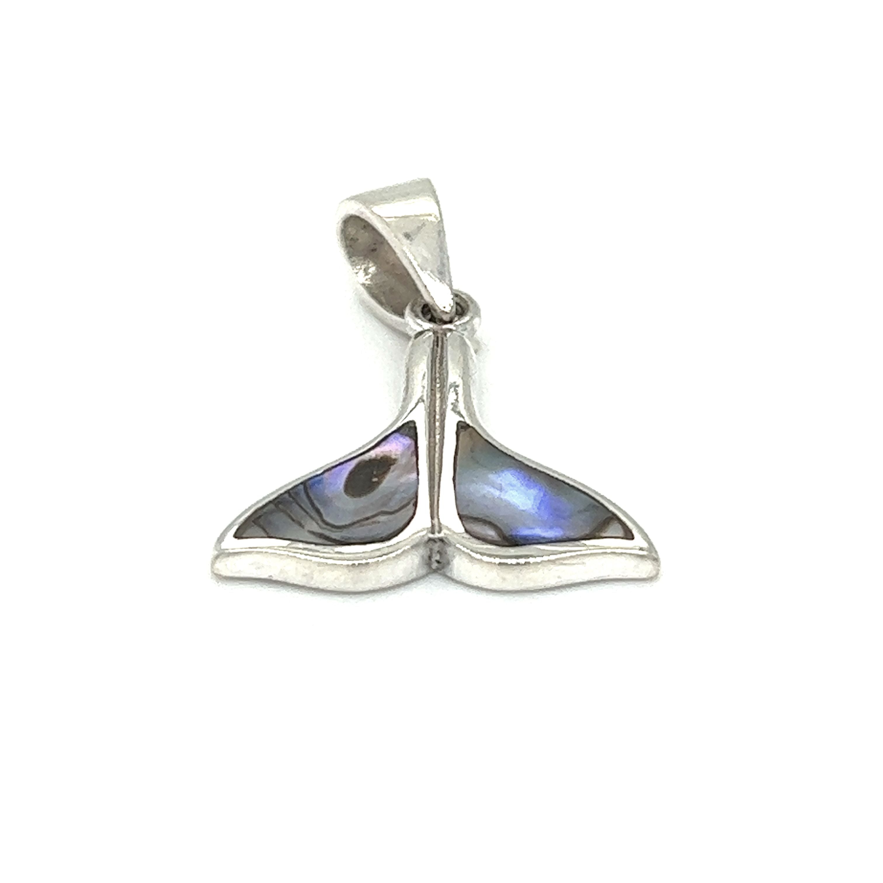 A Simple Whale Tail Pendant with Inlay Stones from Super Silver on a white background, reminiscent of the ocean waves in Santa Cruz.