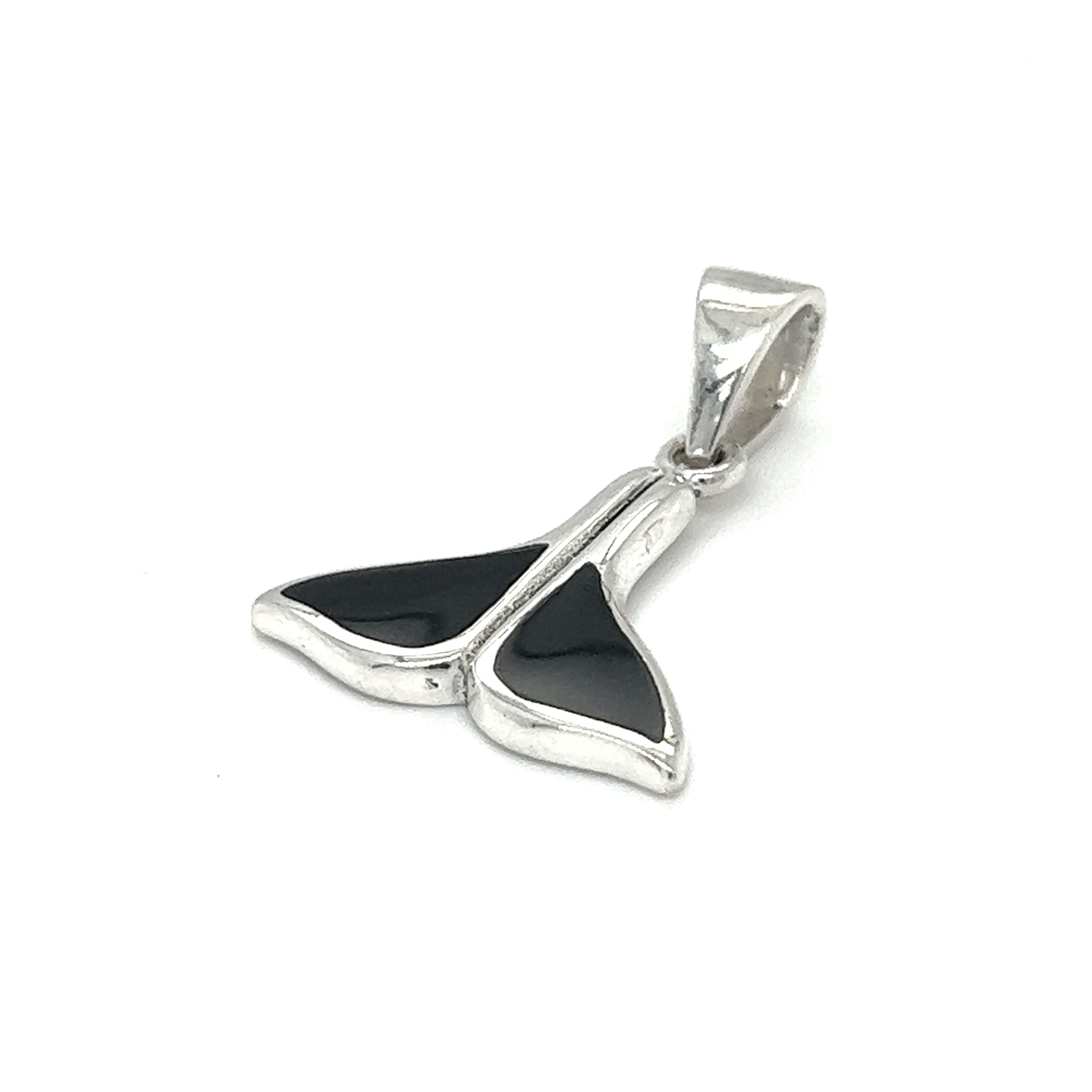 A Super Silver Simple Whale Tail Pendant with Inlay Stones, adorned with a black and white whale tail, perfect for ocean conservation enthusiasts.