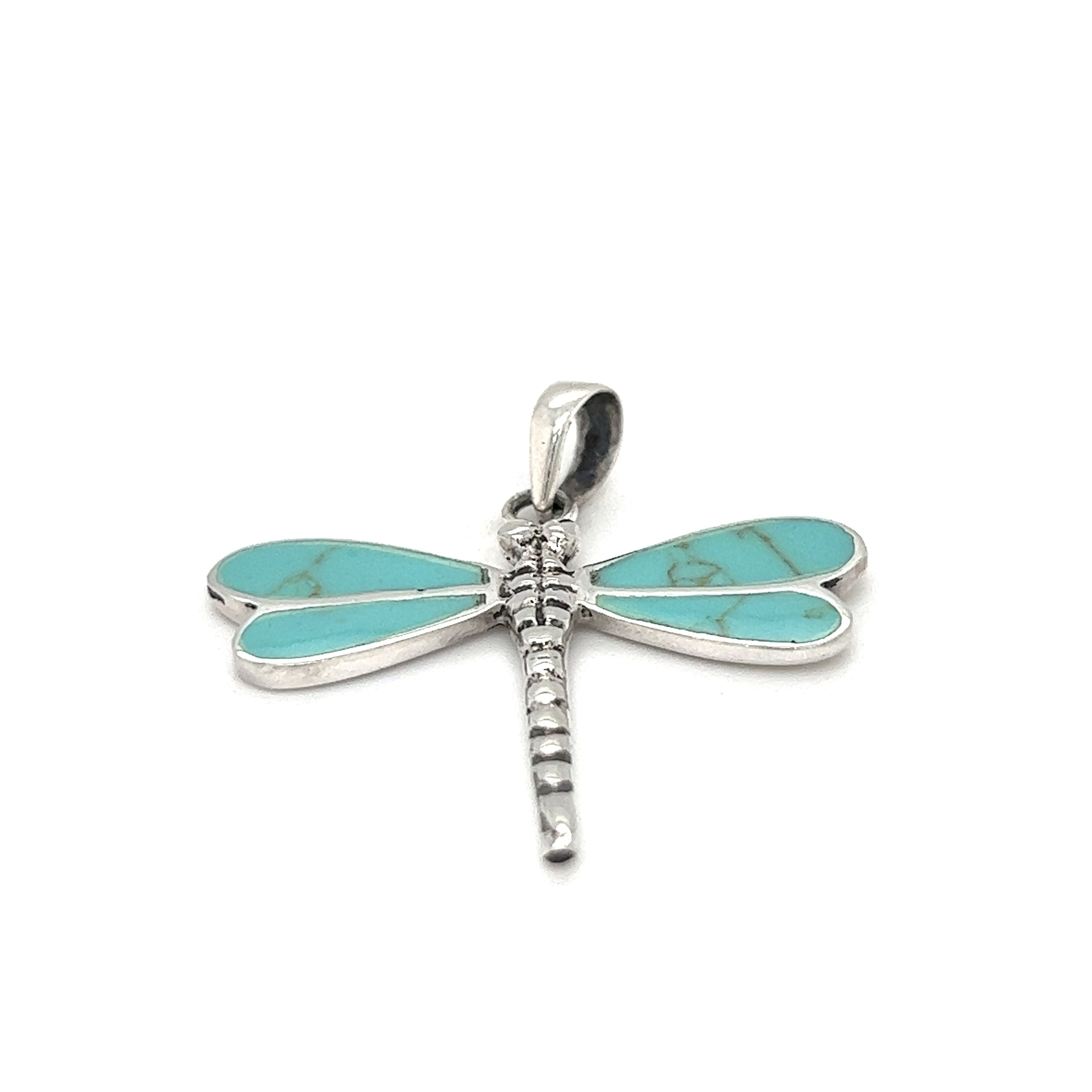 A Super Silver Dragonfly Inlay Stone Pendant with turquoise stone, featuring abalone accents.
