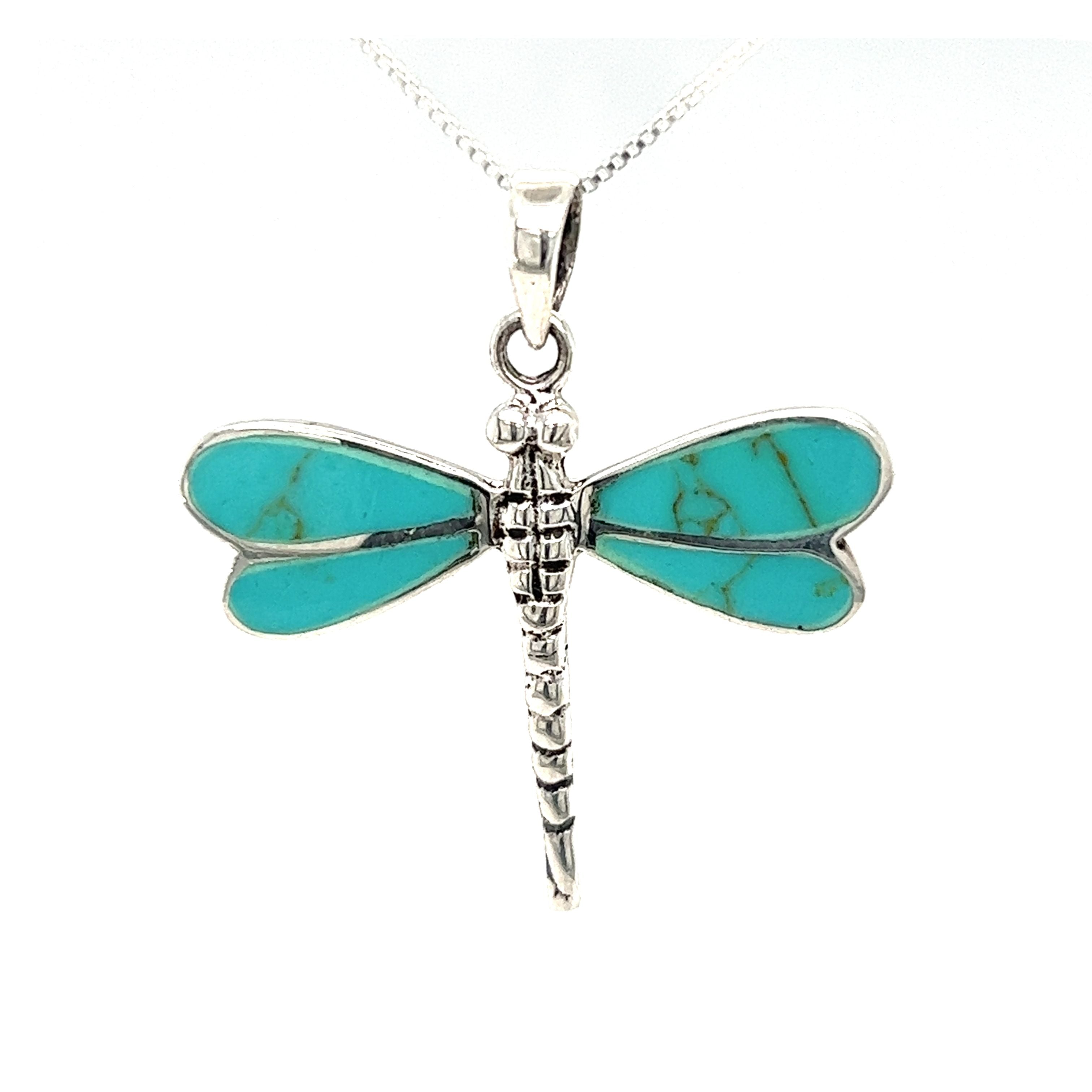 A Dragonfly Inlay Stone Pendant with a turquoise stone on a Super Silver chain.