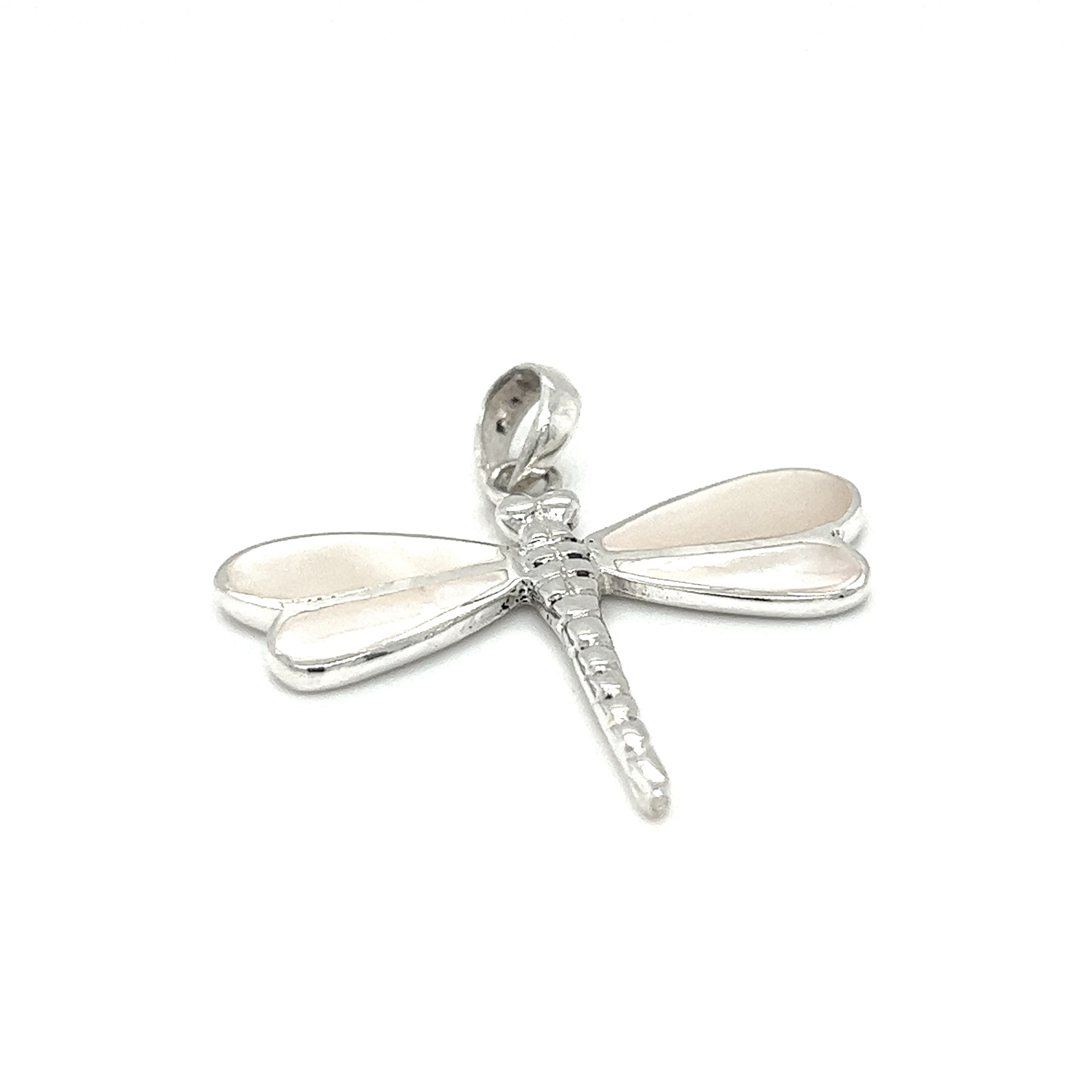 A Super Silver Dragonfly Inlay Stone Pendant featuring abalone and mother of pearl accents, resting delicately on a pristine white background.