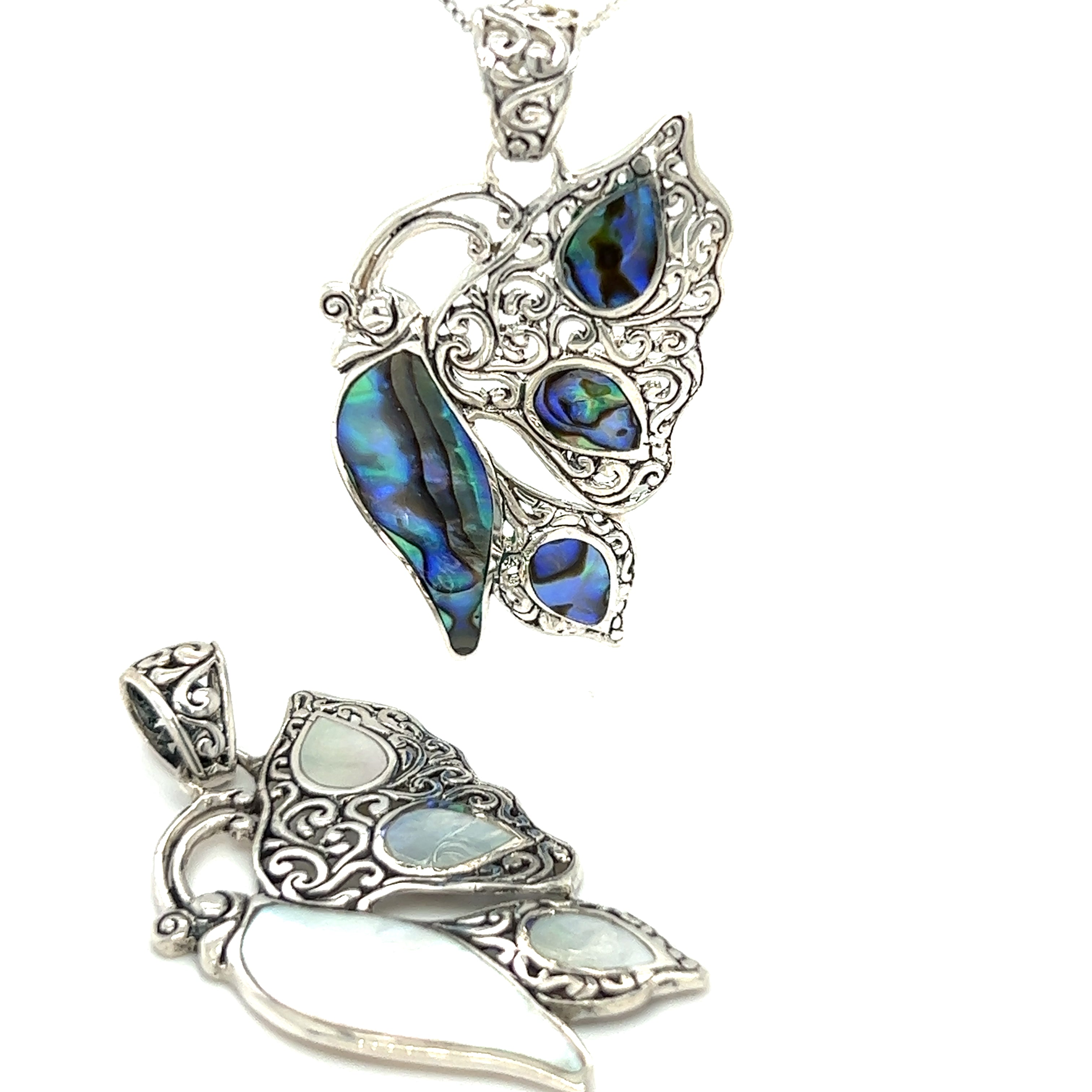 A Filigree Butterfly Inlay Pendant with a silver abalone shell, symbolizing transformation.