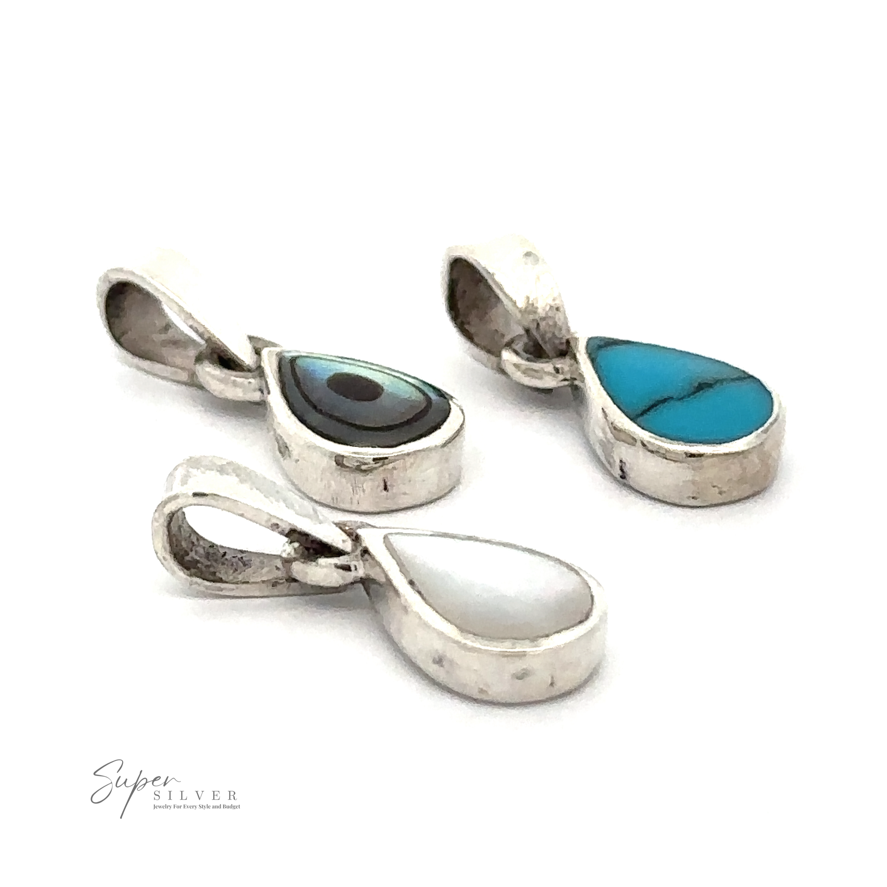 Three Tiny Inlay Teardrop Pendants with different inlays: one with a blue stone, one with a white stone, and one with a multicolored concentric design. The image features the Super Silver logo in the corner, showcasing the elegance of minimal jewelry.