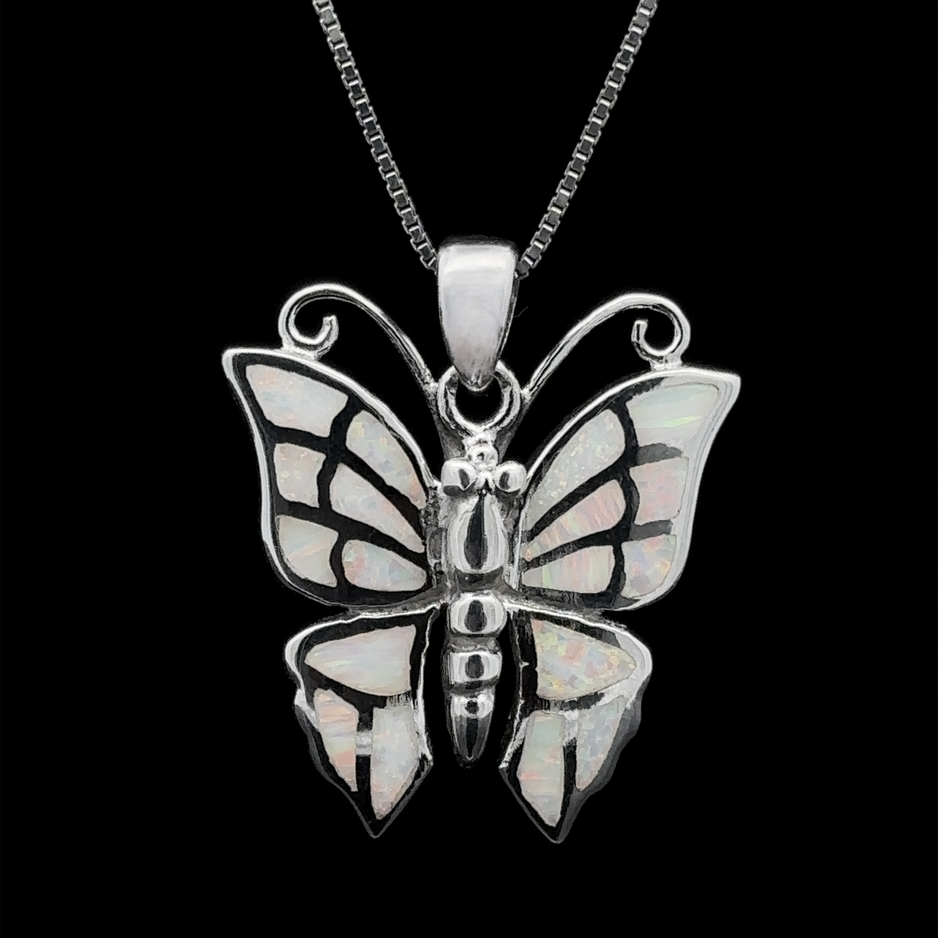 Presenting the Lab-Created Opal Butterfly Pendant, a sterling silver necklace featuring iridescent lab-created opal inlays on butterfly wings, elegantly set against a black background.