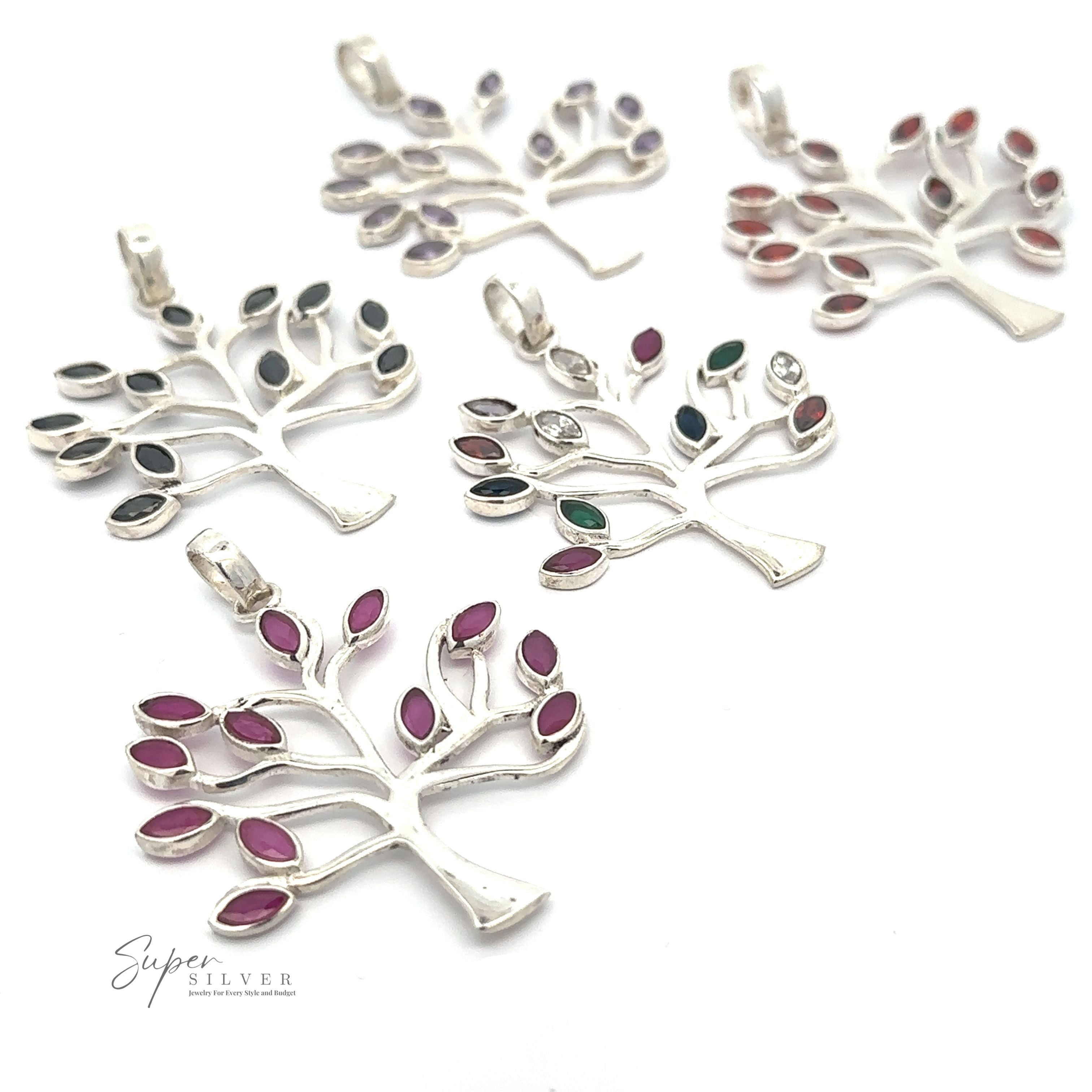 Five Tree of Life Pendant with Stone Leaves displayed on a white background, each featuring a unique arrangement of gemstones. The .925 sterling silver craftsmanship adds an elegant touch to these beautiful pieces.
