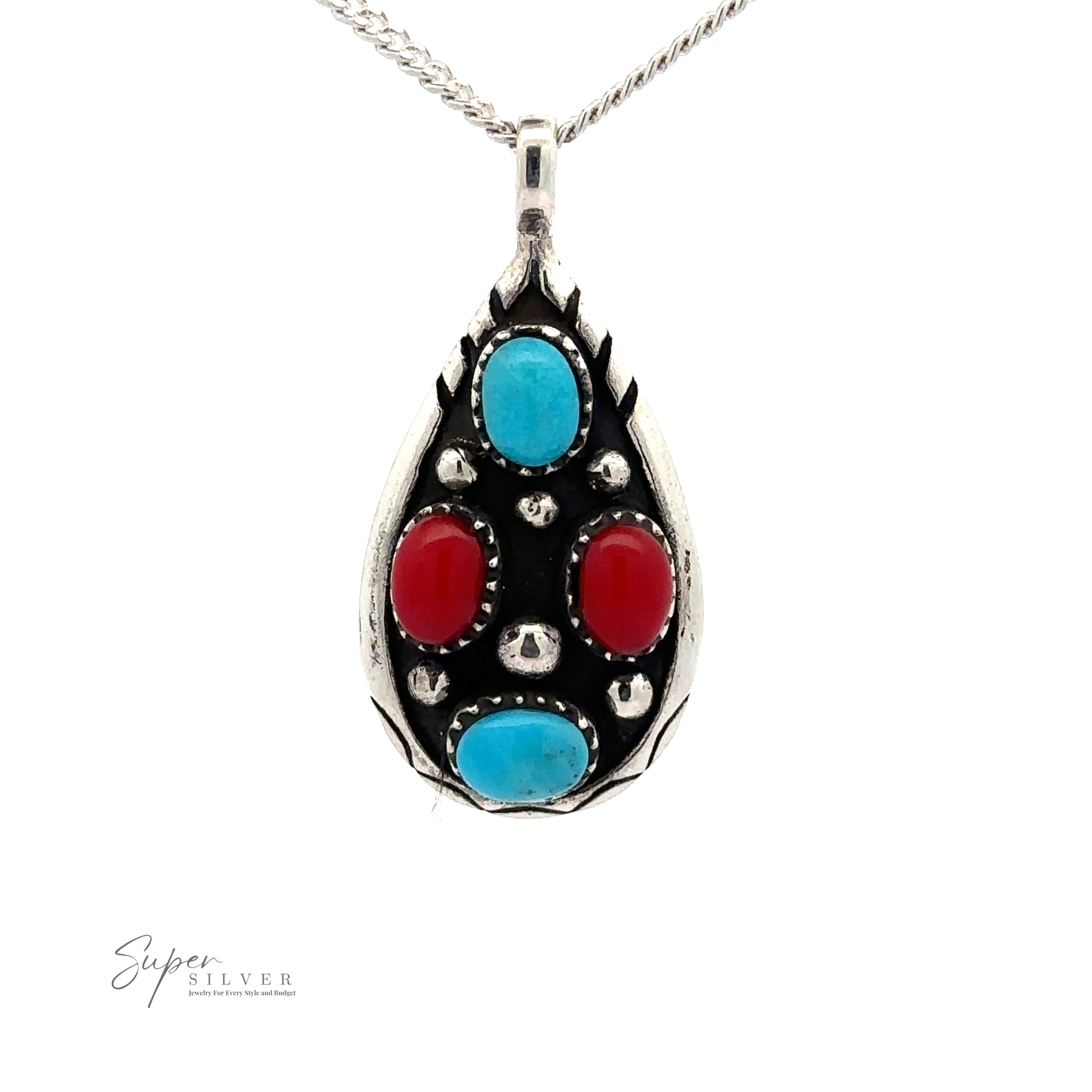 A Teardrop Turquoise and Coral Pendant with two blue turquoise stones and two red stones on a silver chain. The intricate metalwork showcases a silver teardrop-shaped design. The logo "Super Silver" is visible in the bottom left corner.