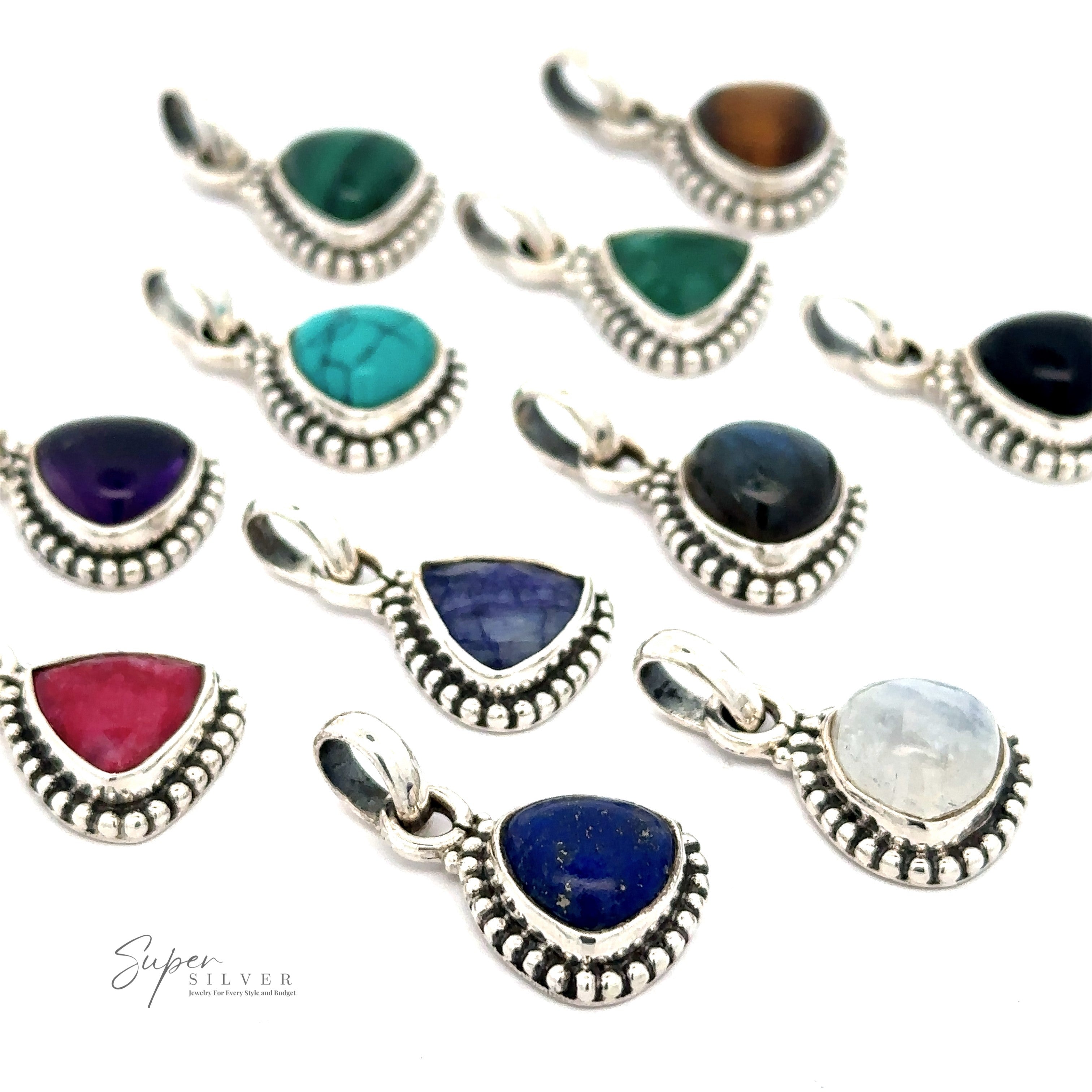 A collection of eleven Beautiful Triangular Shape Stone Pendants With Beaded Design, each set in sterling silver frames with intricate beaded designs, arranged on a white surface. The stones are various colors including green, blue, purple, red, and black.