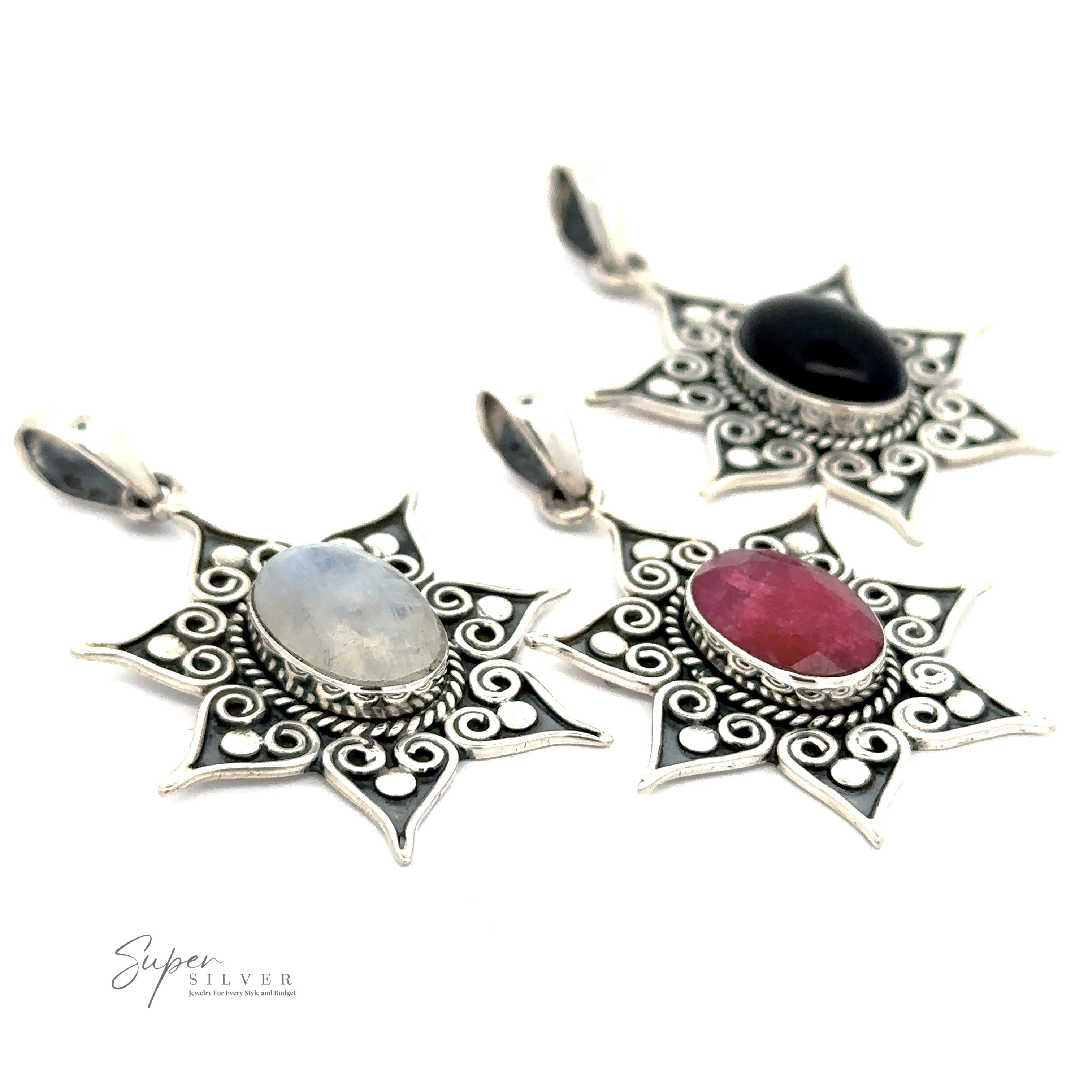 Three Floral Design Gemstone Pendants featuring oval gemstones: one with a moonstone, another with a red stone, and the third with onyx.