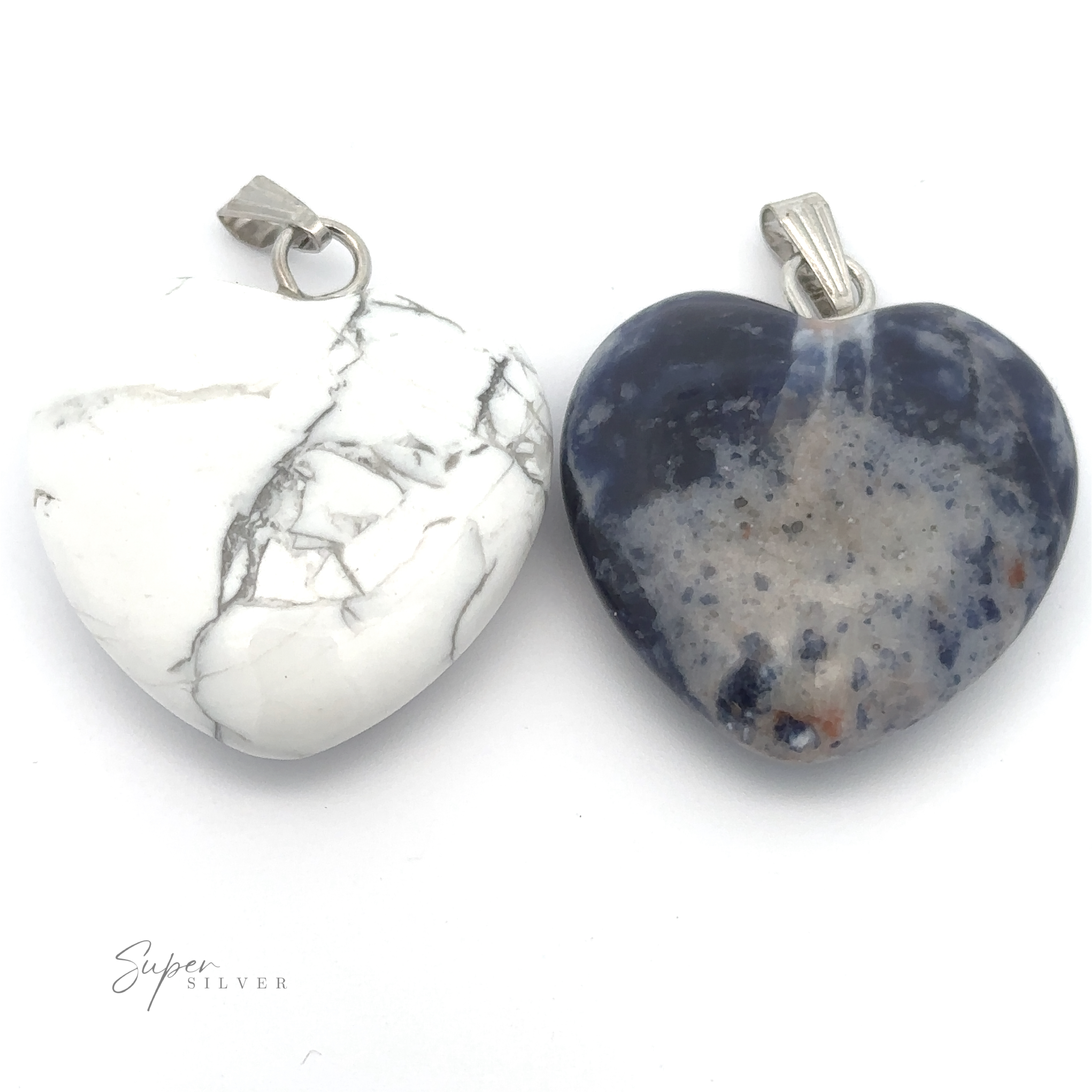 Two Heart Stone Pendants side by side on a white background; the left stone is white with gray marbling, and the right stone is dark blue with lighter gray and white specks. Perfect for everyday wear, these mixed metals pieces exude elegance and charm.