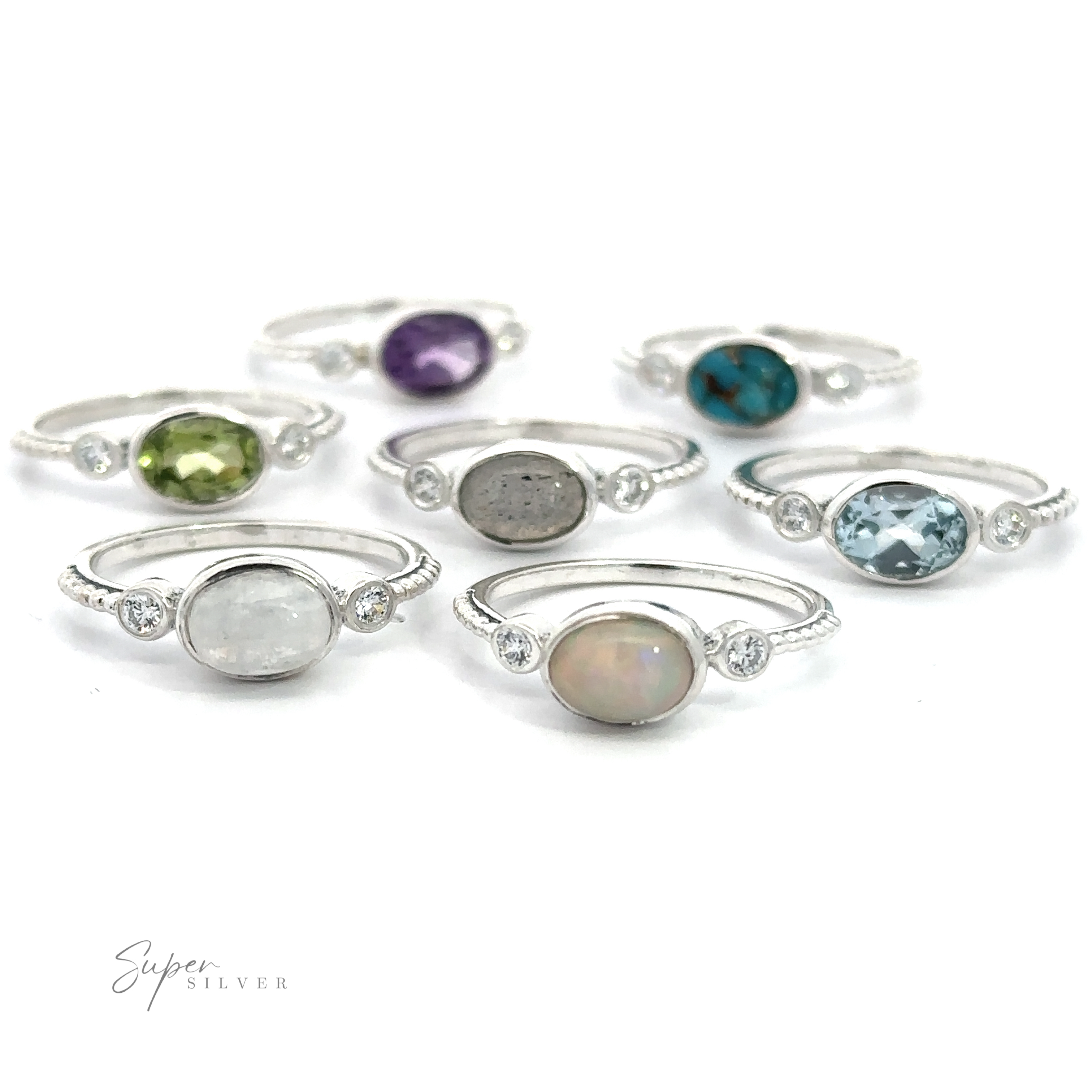 A collection of eight Horizontal Oval Gemstone Rings with Beaded Bands displayed on a white background.