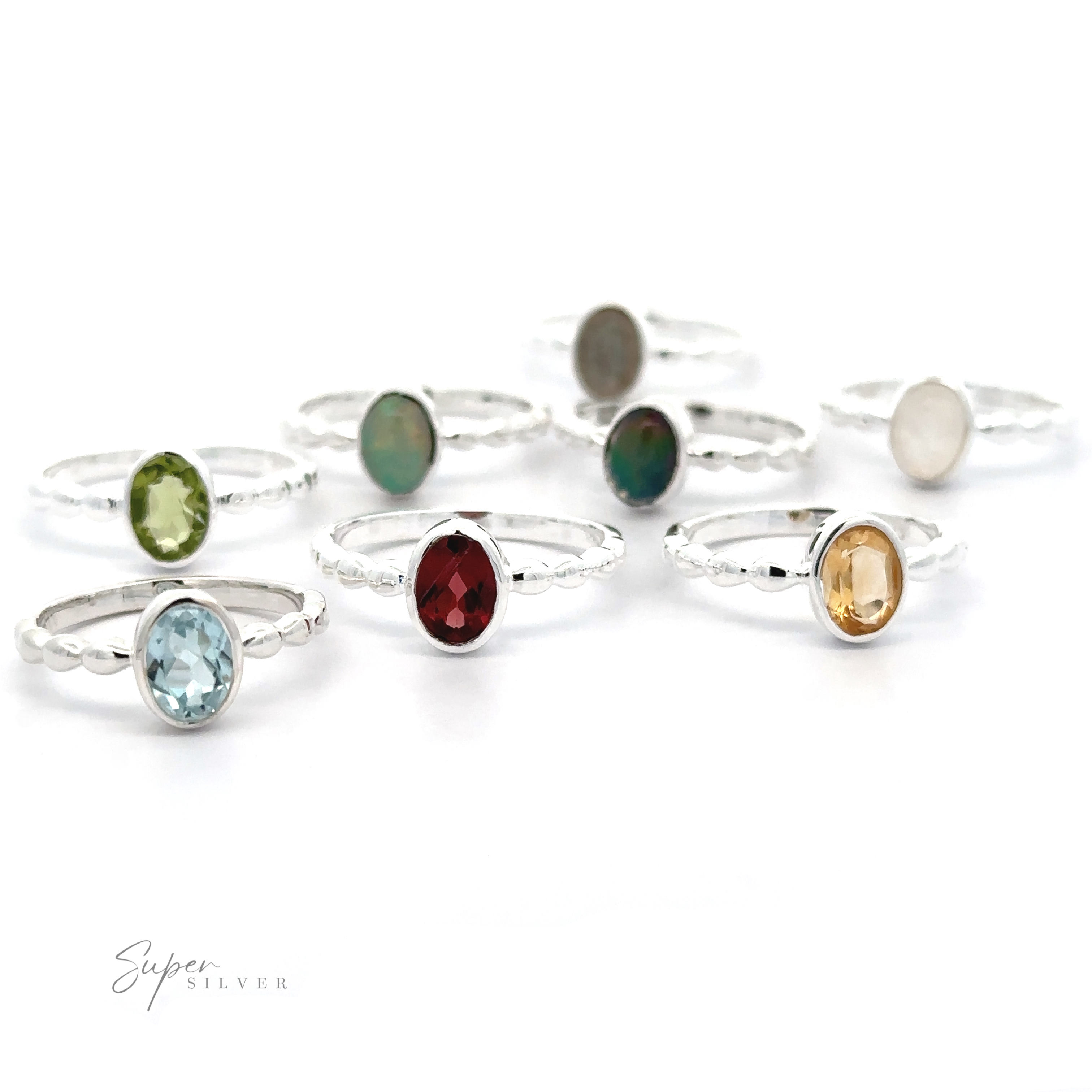 A collection of Oval Gemstone Rings with Beaded Bands displayed on a white background.