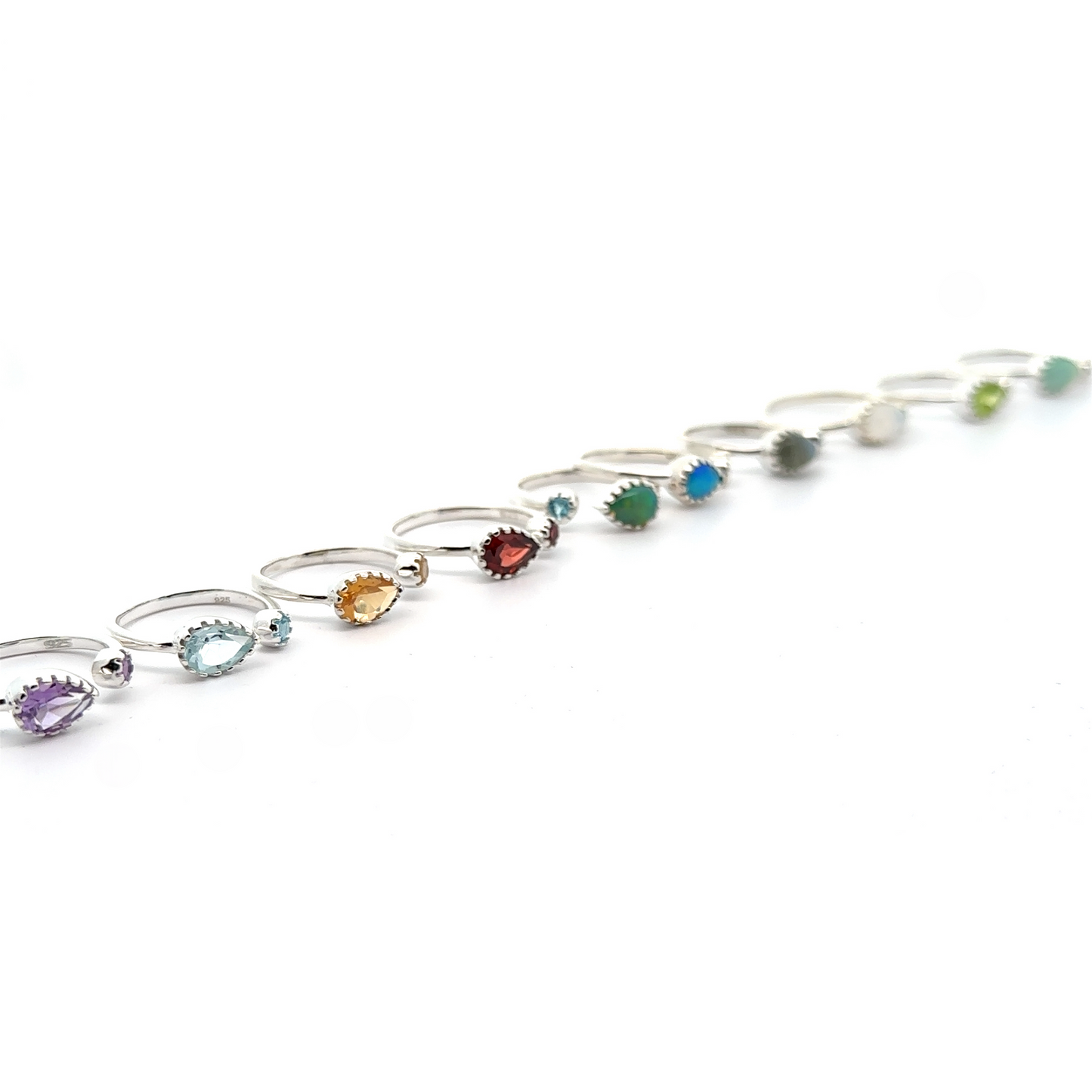 A series of Dainty Adjustable Gemstone Rings with Two Stones arranged in a curve on a white background.