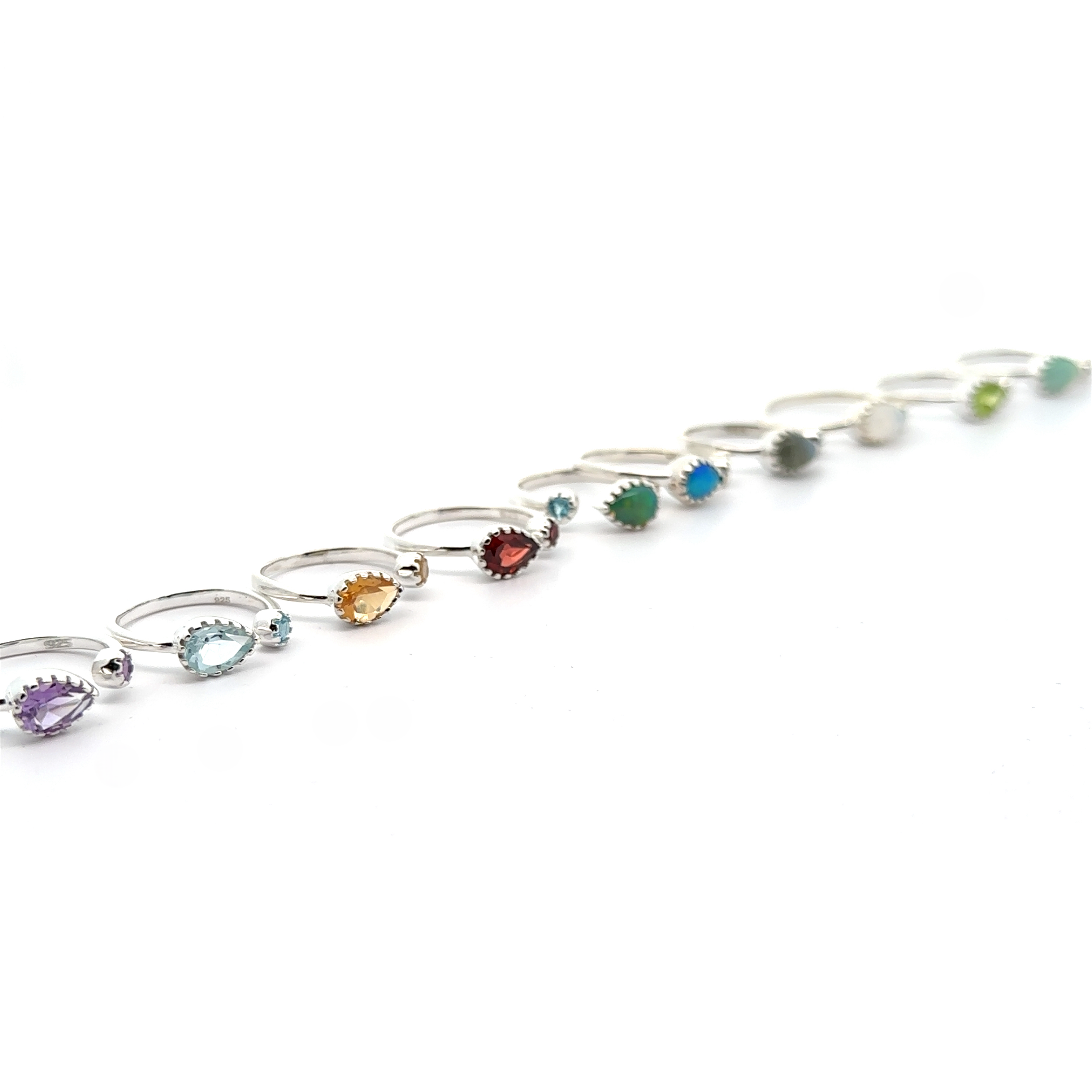 A series of Dainty Adjustable Gemstone Rings with Two Stones arranged in a curve on a white background.