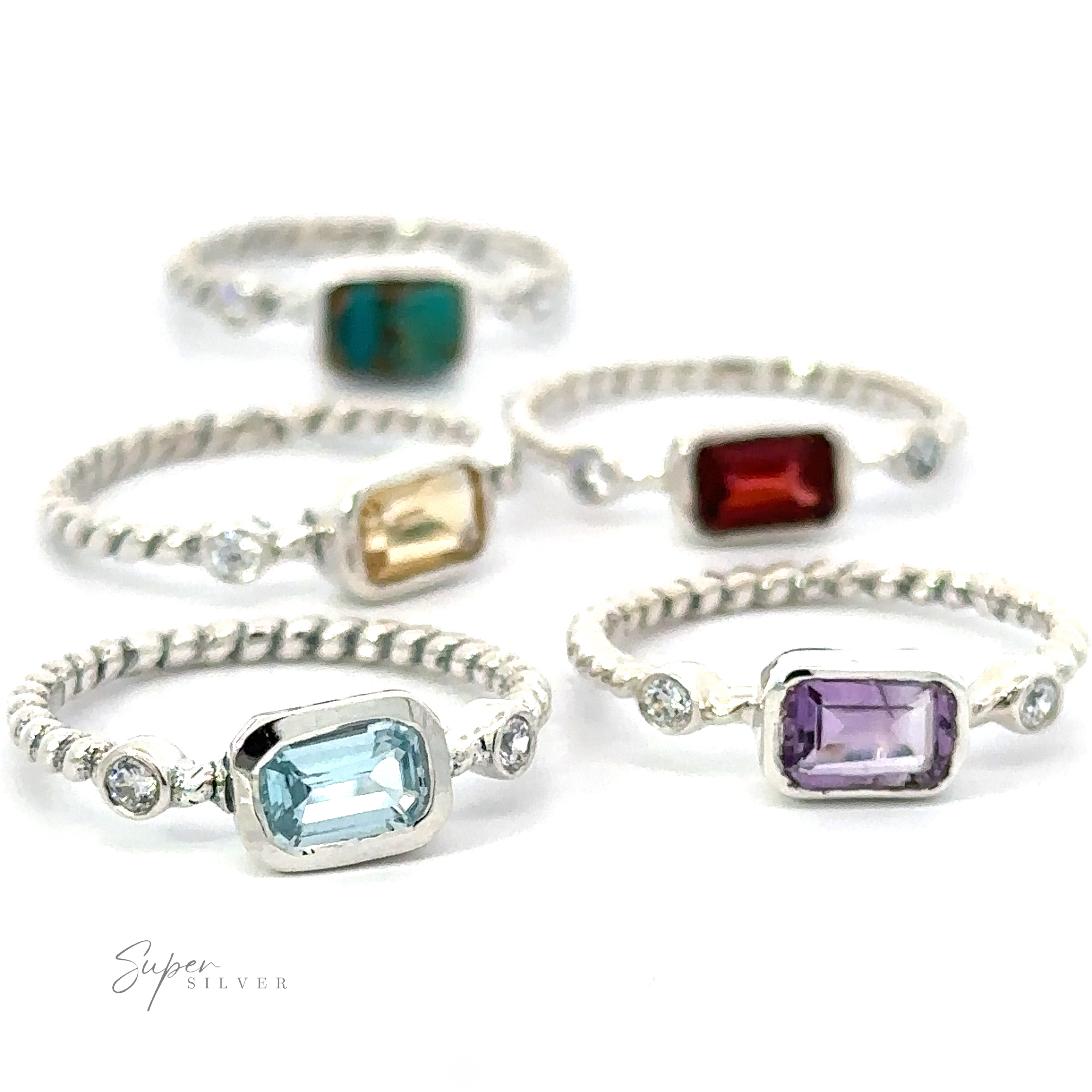 A collection of five Rectangle Gemstone Rings with Twisted Bands in different colored stones on a white background.