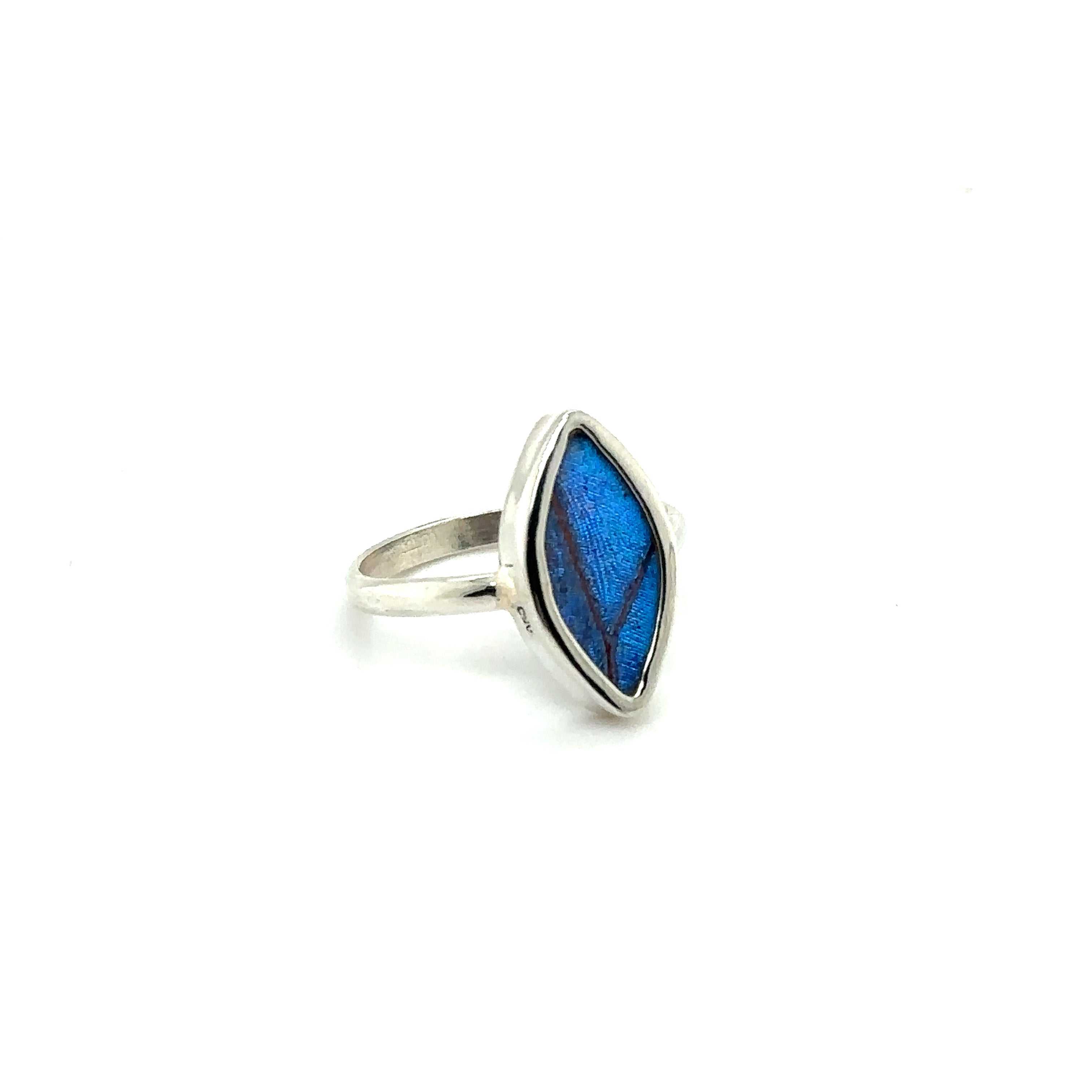 A sustainable fashion statement - a Genuine Butterfly Wing Ring in Marquise Shape with a blue stone in the middle.