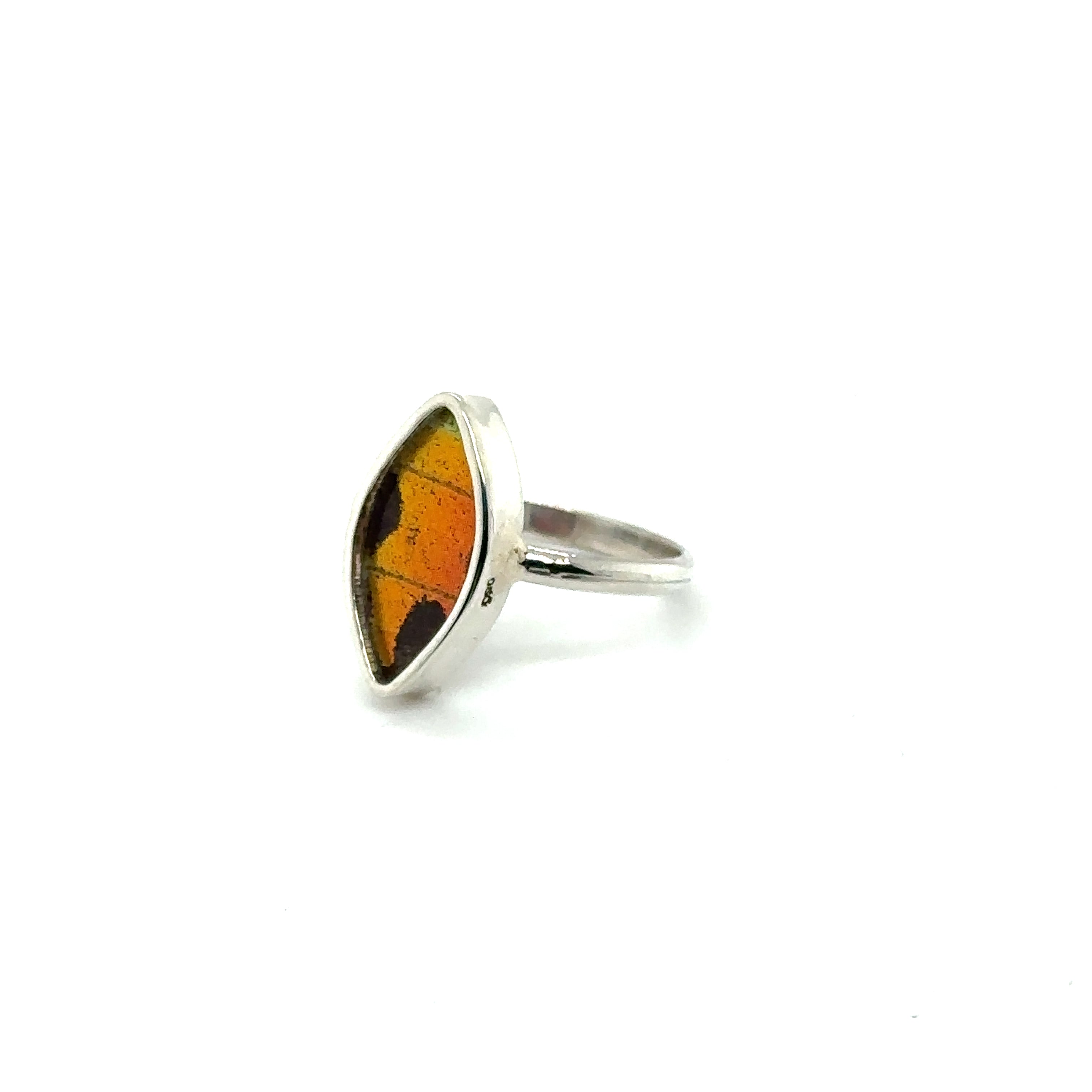 A silver ring with a red and orange stone, perfect for sustainable fashion enthusiasts looking to make a conservation statement with their Genuine Butterfly Wing Rings in Marquise Shape.
