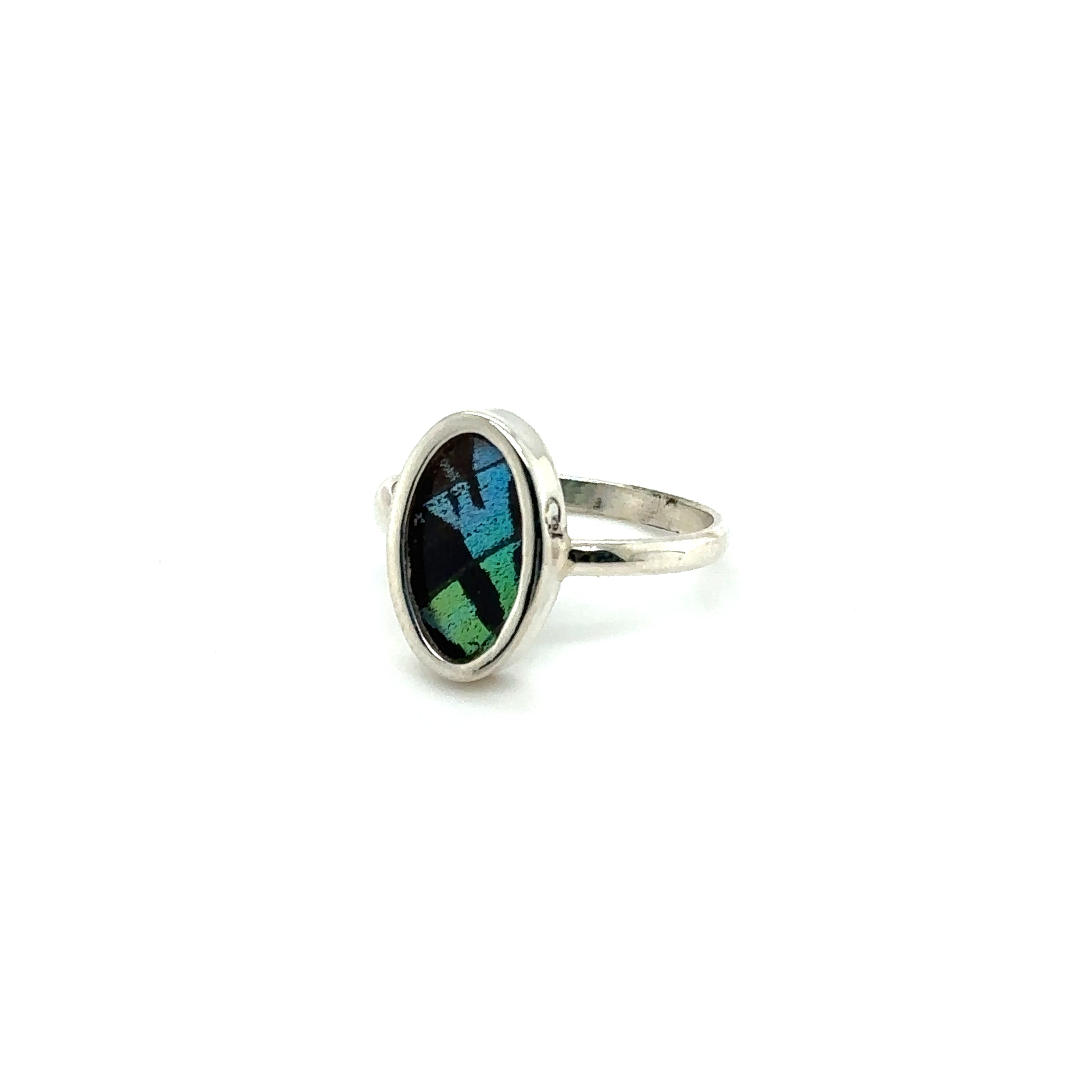 A Genuine Butterfly Wing Ring in Oval Shape with a green stone.