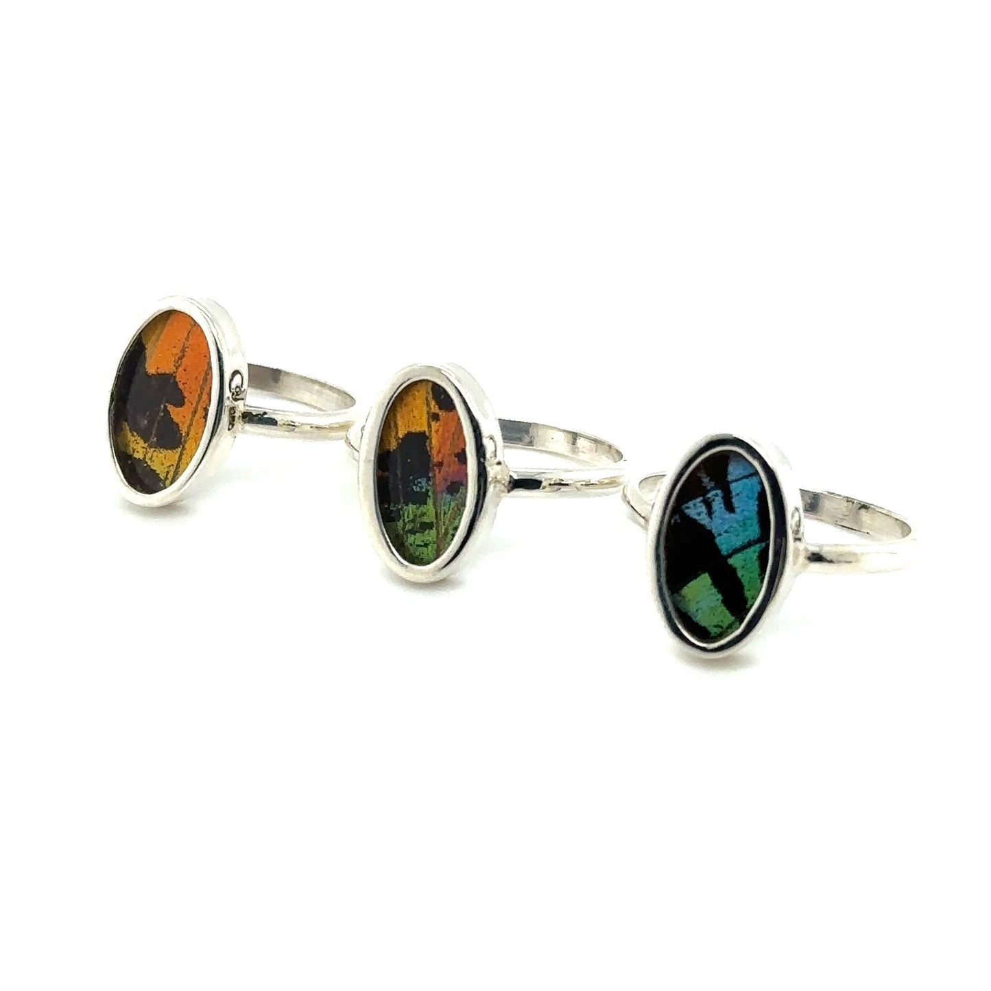 Three Genuine Butterfly Wing Rings in Oval Shape with multicolored glass.