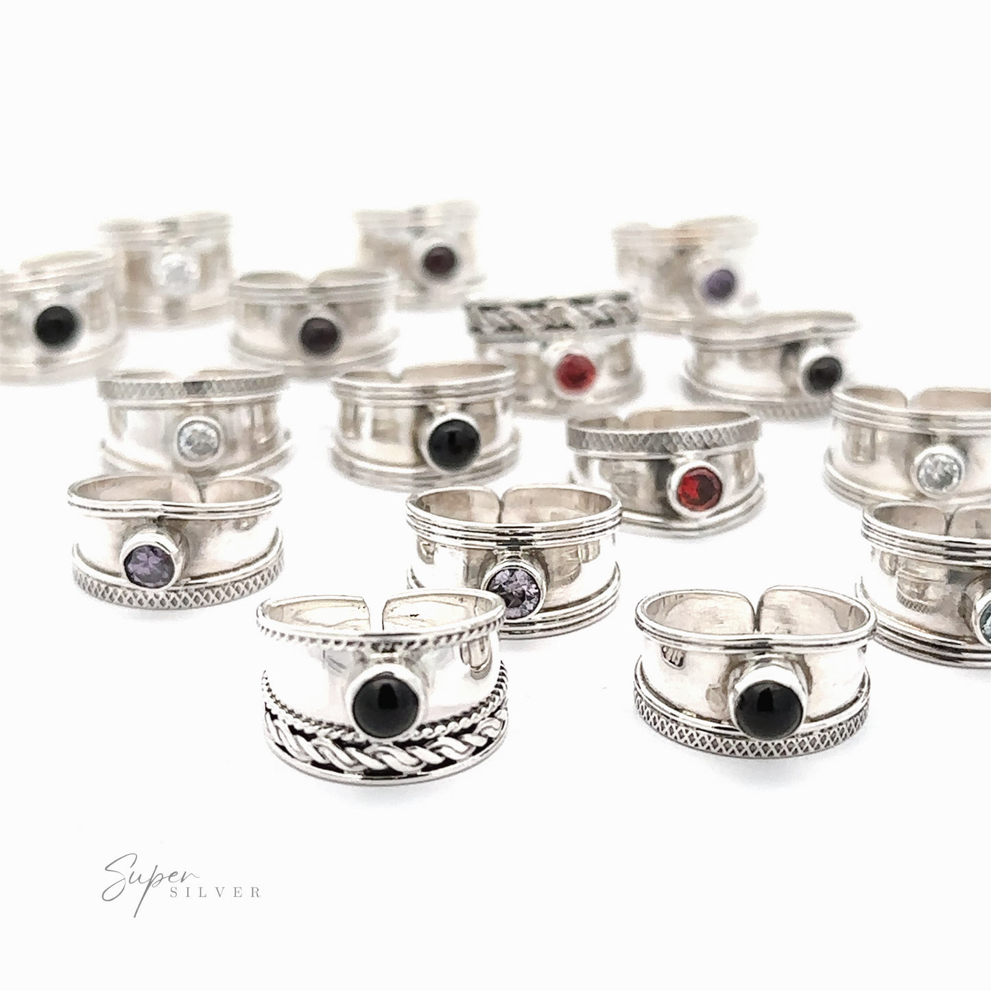 
                  
                    A collection of Adjustable Wide Cigar Band Toe Rings with Gemstones displayed on a white surface.
                  
                