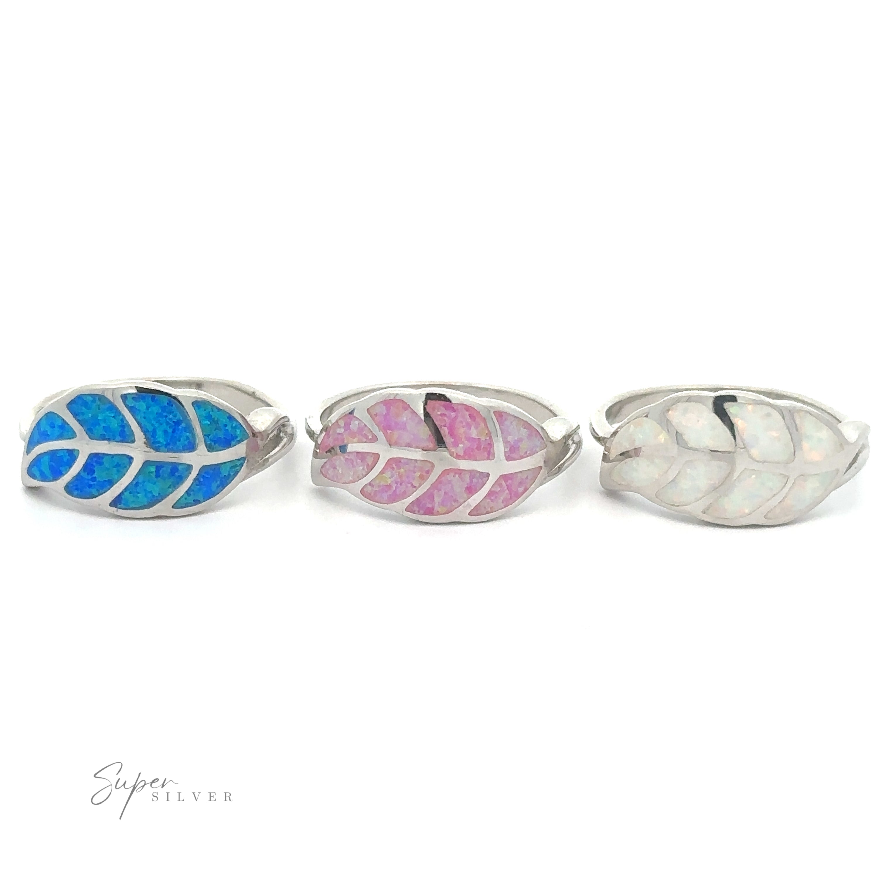 Three Lab Opal Feather Rings displayed in a row.
