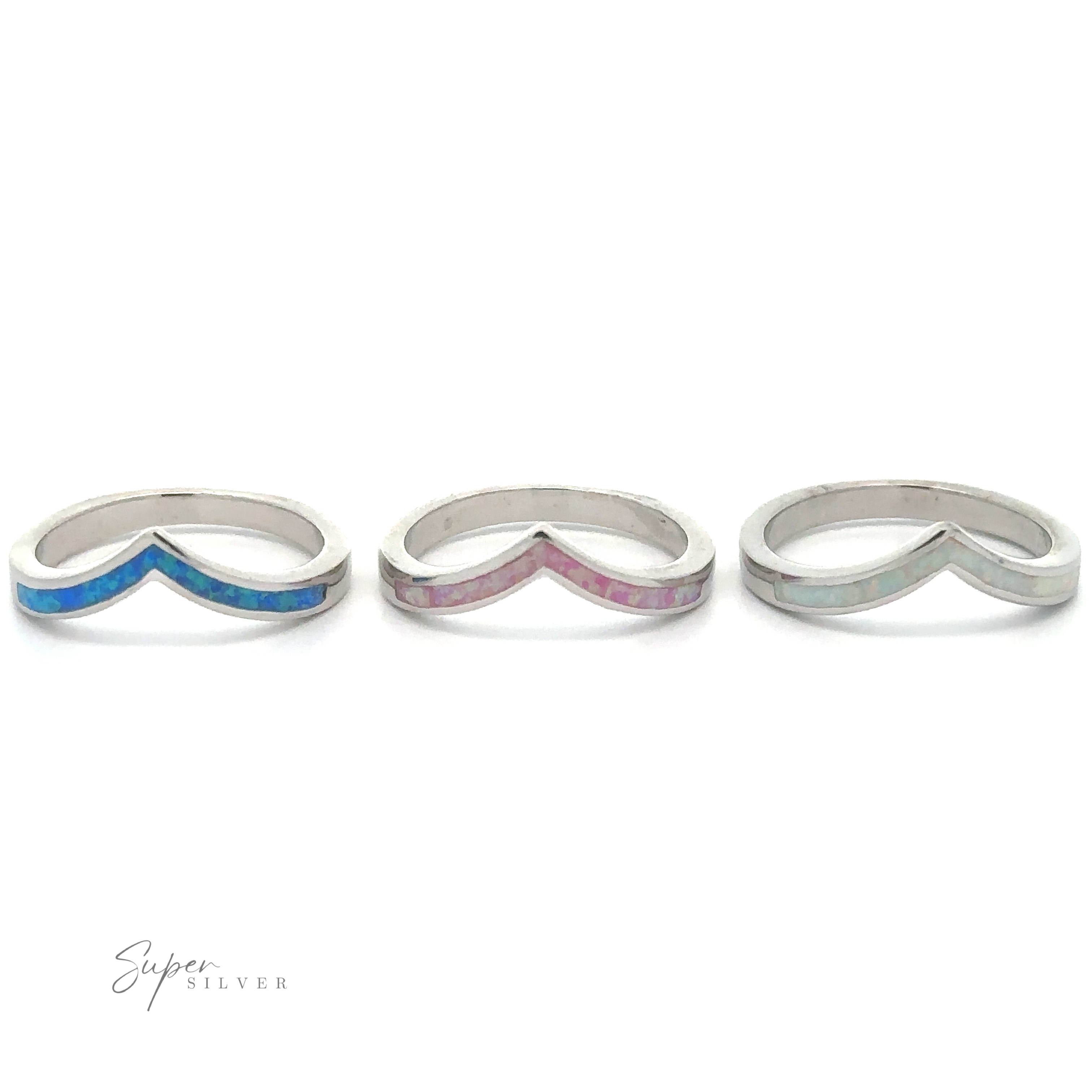 Three Elegant Chevron Lab Opal Rings with different colored inlays on a white background, perfect for stacking.