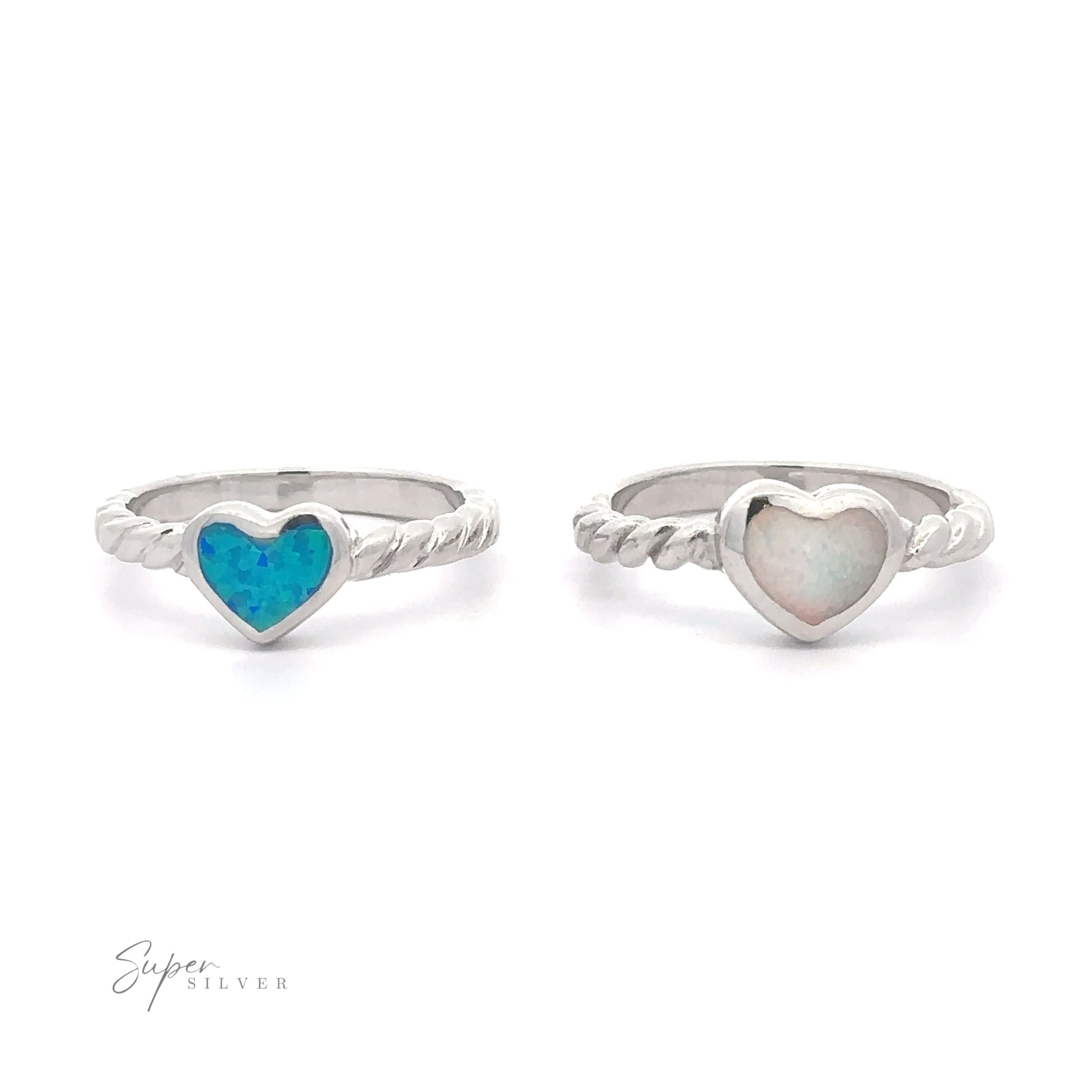 Two Lab Opal Heart Rings with Twisted Bands on a white background.