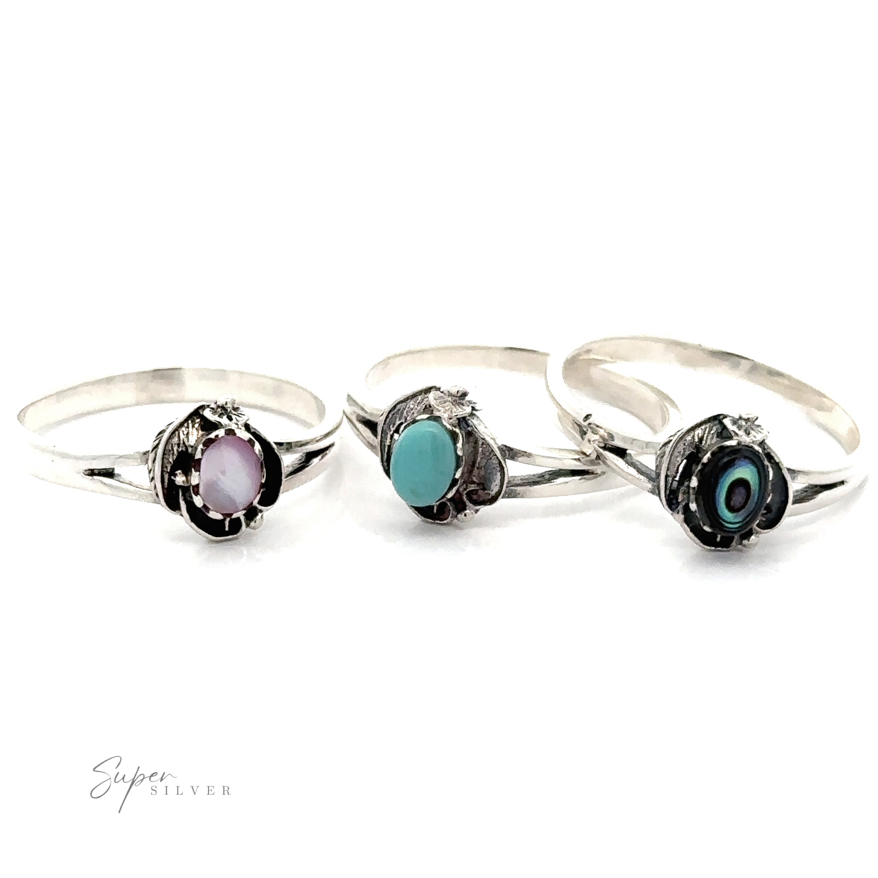 The "Inlay Stone Ring With Delicate Detailing" collection features three sterling silver rings with oval gemstones: a lavender gem, a turquoise gem with Southwest flair, and a dark gem embellished with concentric circles.