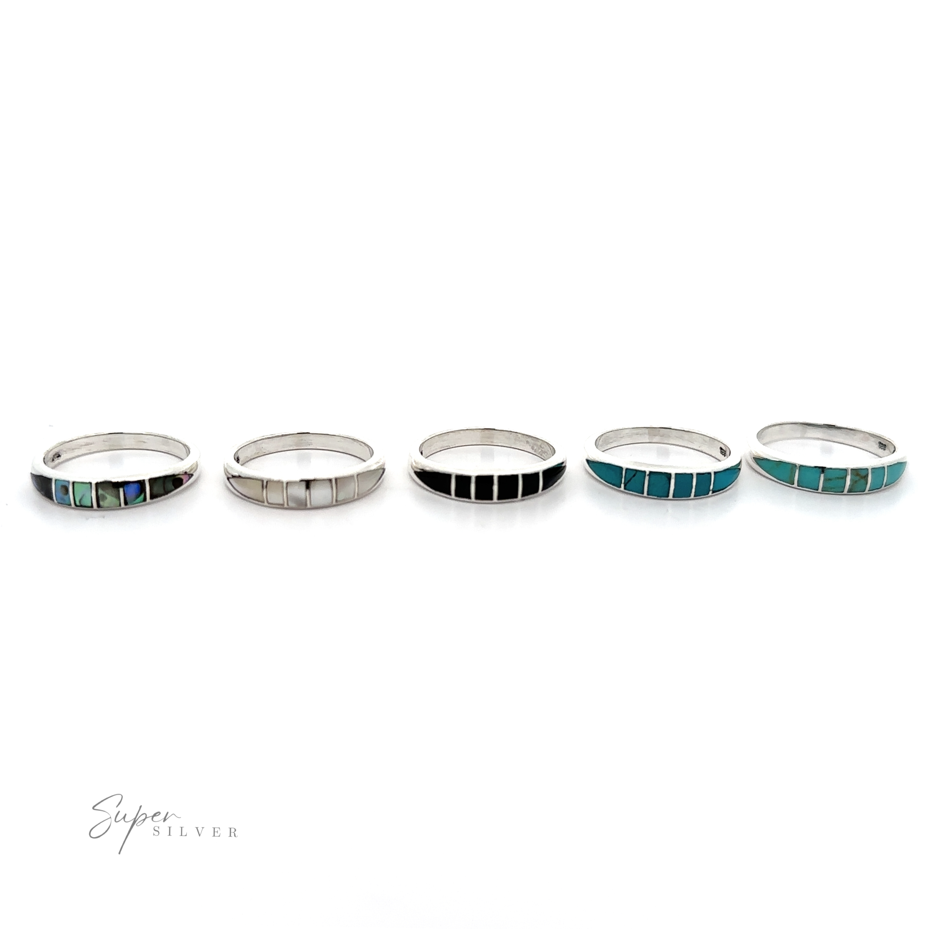 A row of sterling silver stacking rings with turquoise and the Inlay Stone Band.