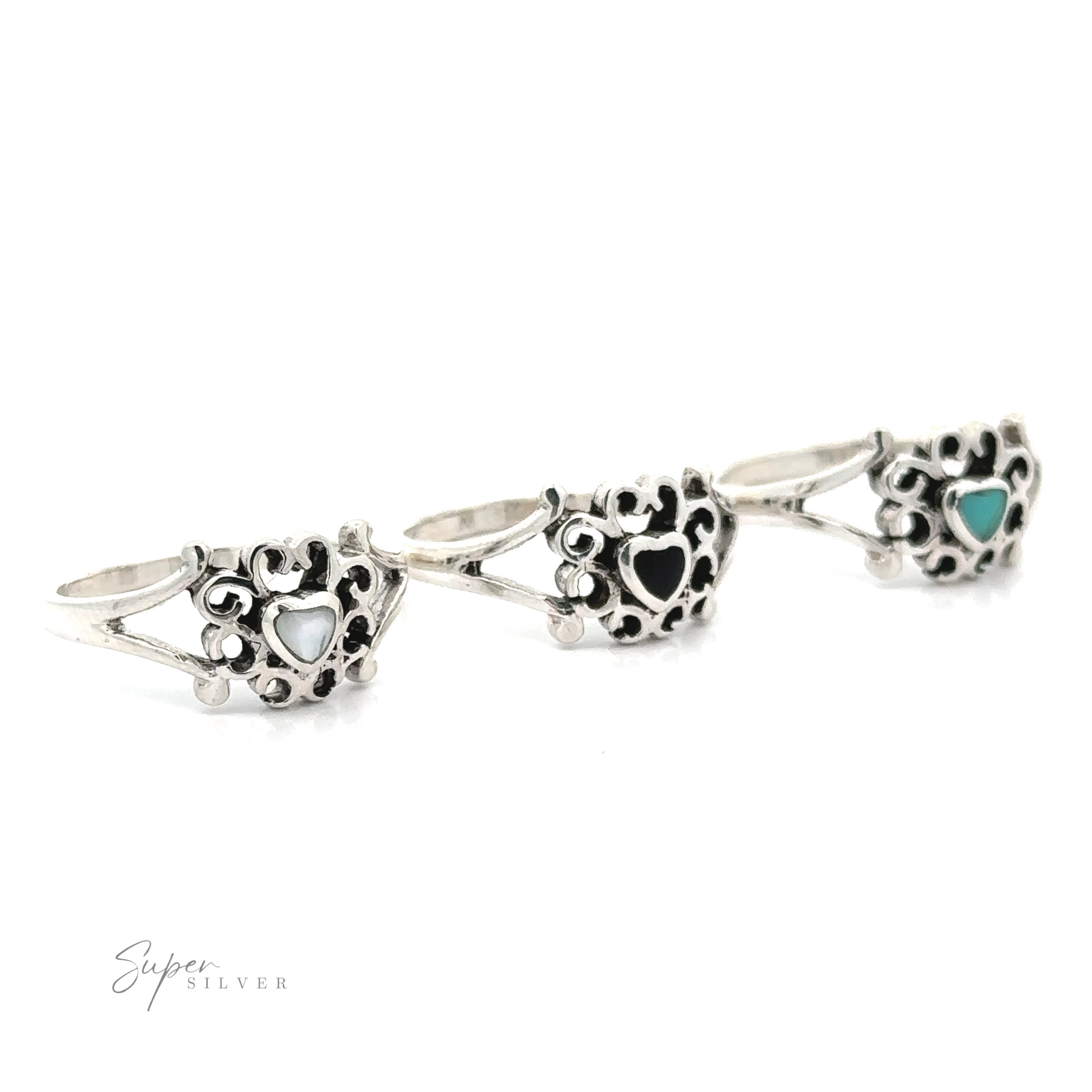 Three Filigree Design Surround Inlaid Stone Heart rings with turquoise stones.