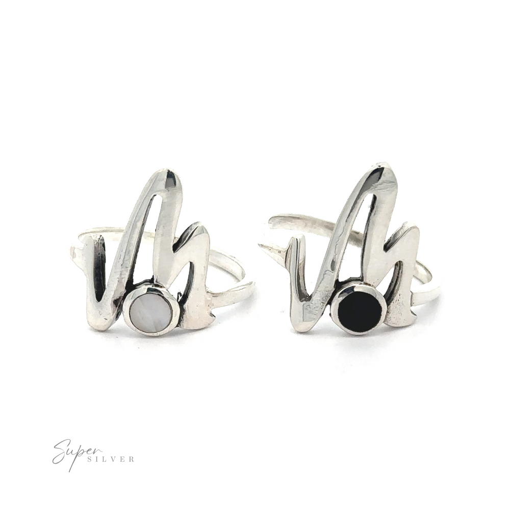 A pair of silver rings with a hand gesture design and Stone inlay Zig Zag ring embellishment.