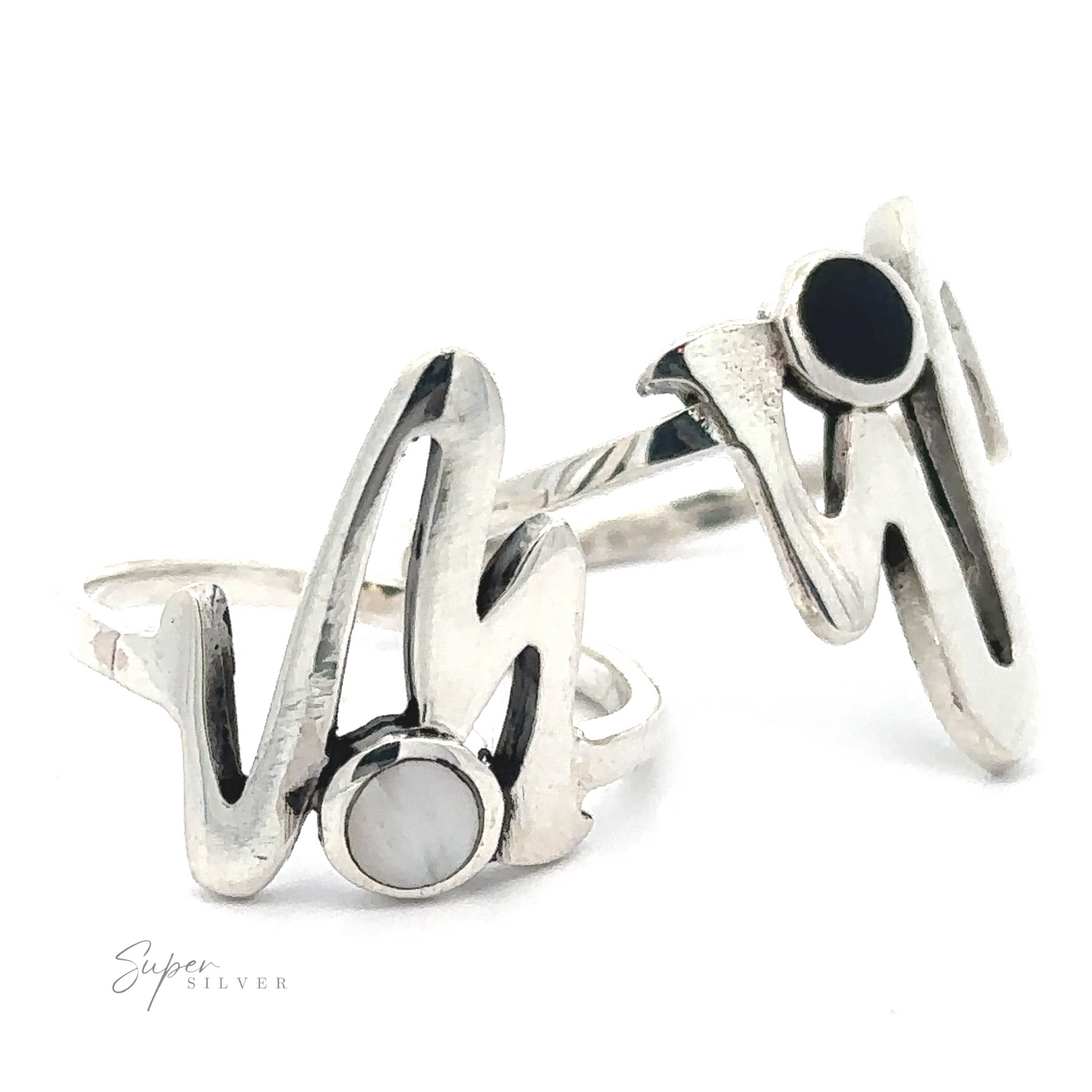 A pair of Stone Inlay Zig Zag rings with a stylized "w" design, featuring onyx circular insets, against a white background.