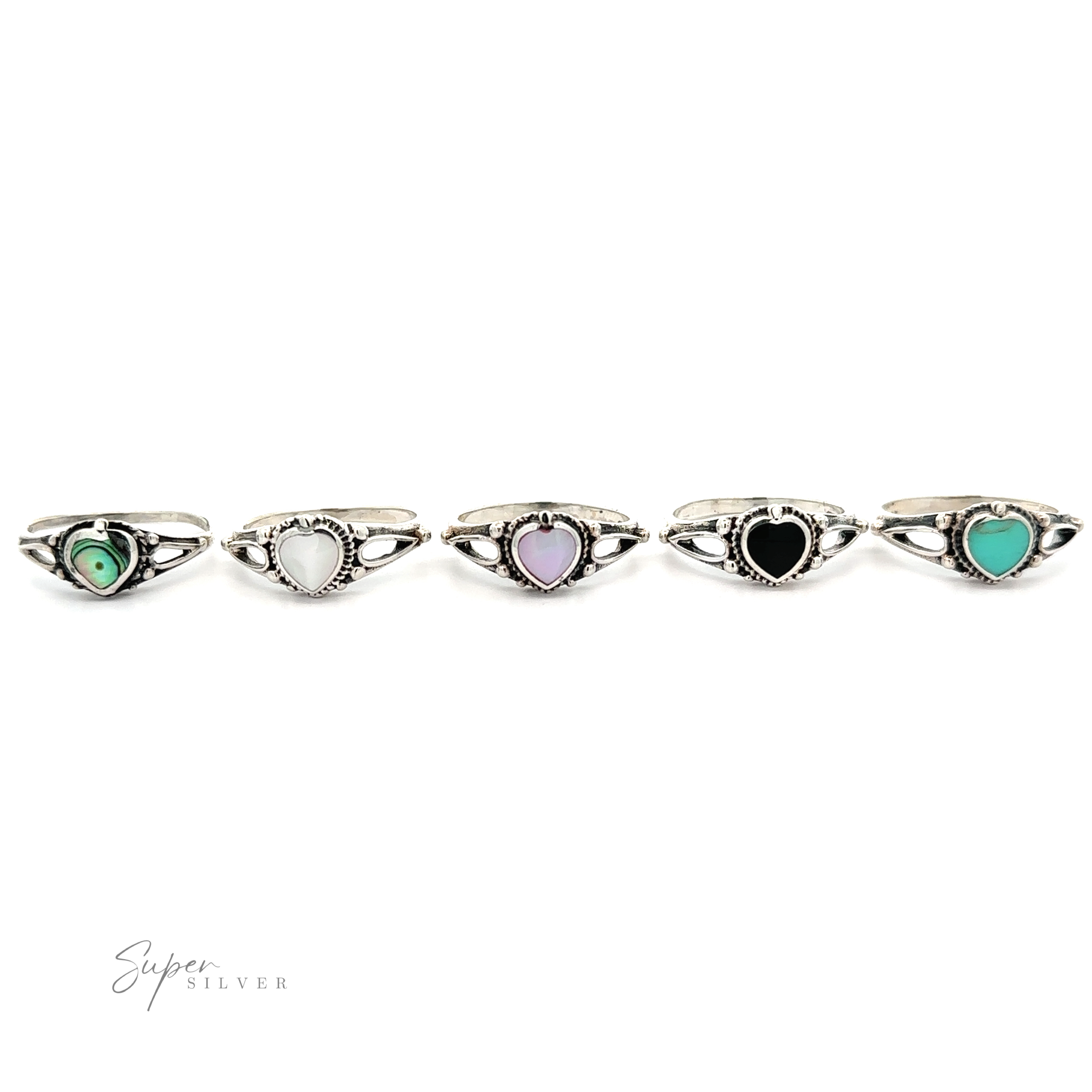 A collection of five silver inlaid stone heart rings, displayed in a row against a white background.