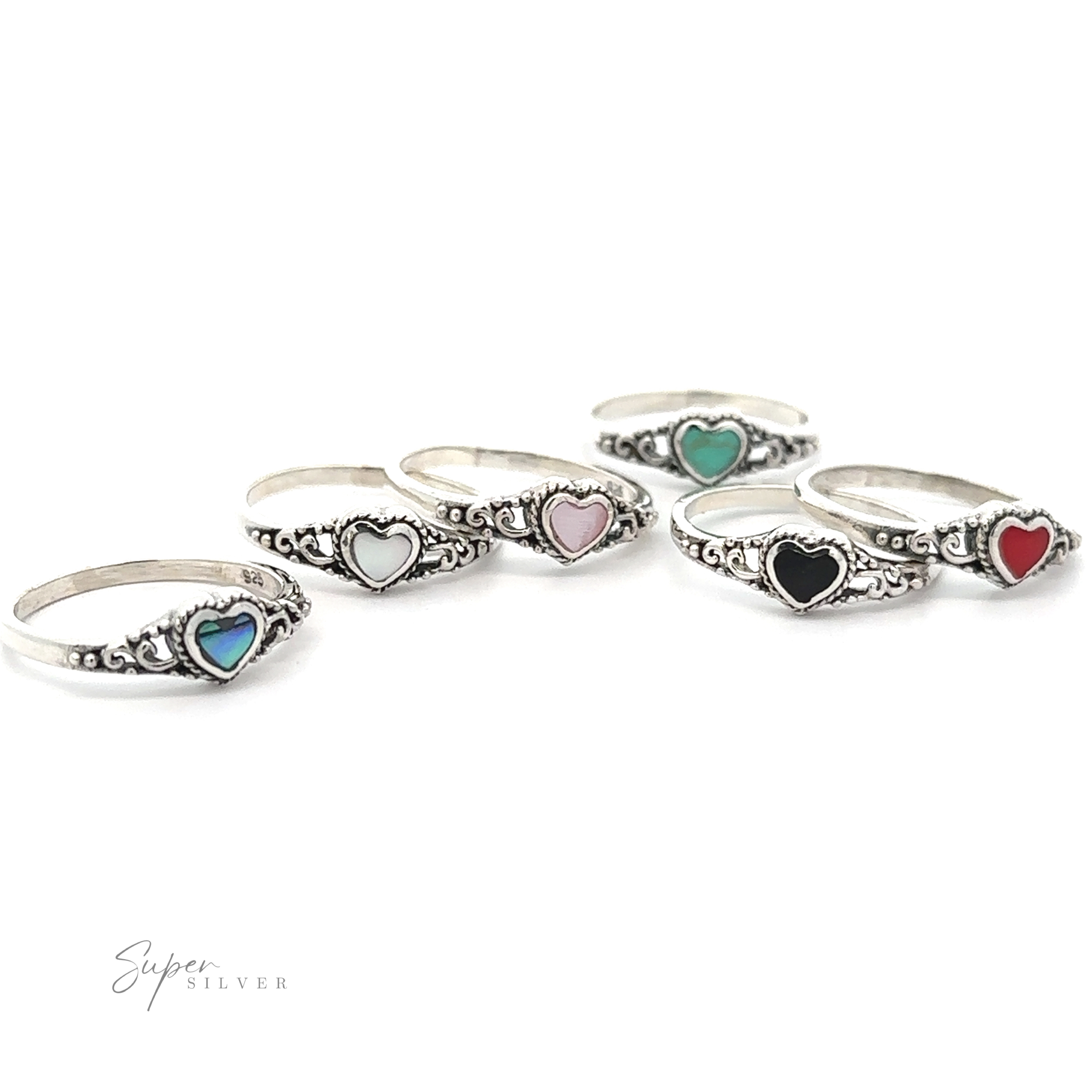 Four Dainty Heart Filigree Rings with Inlaid Stones feature a Bali-style filigree design.
