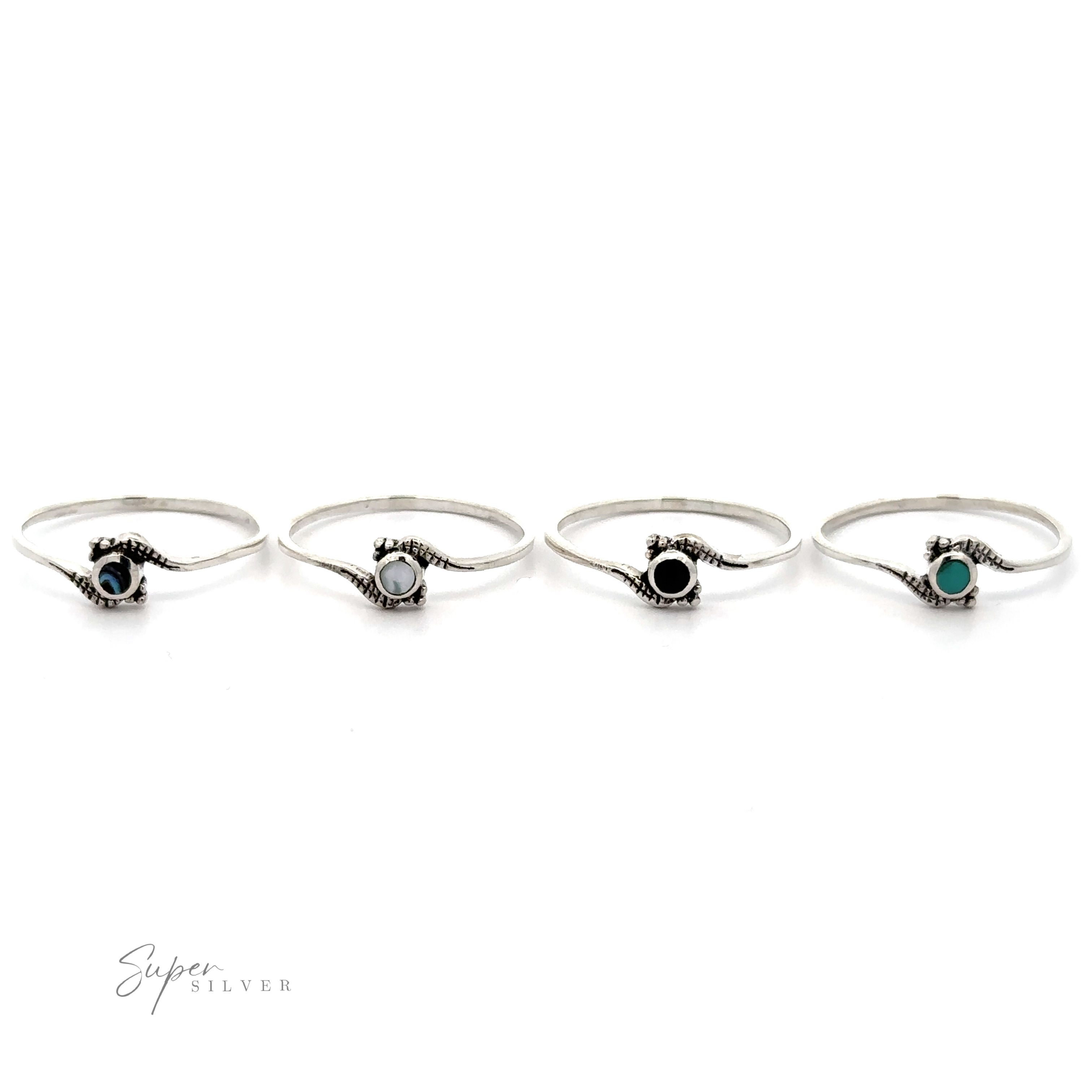 Four Tiny Freeform Rings with centered round turquoise gemstones on a white background.