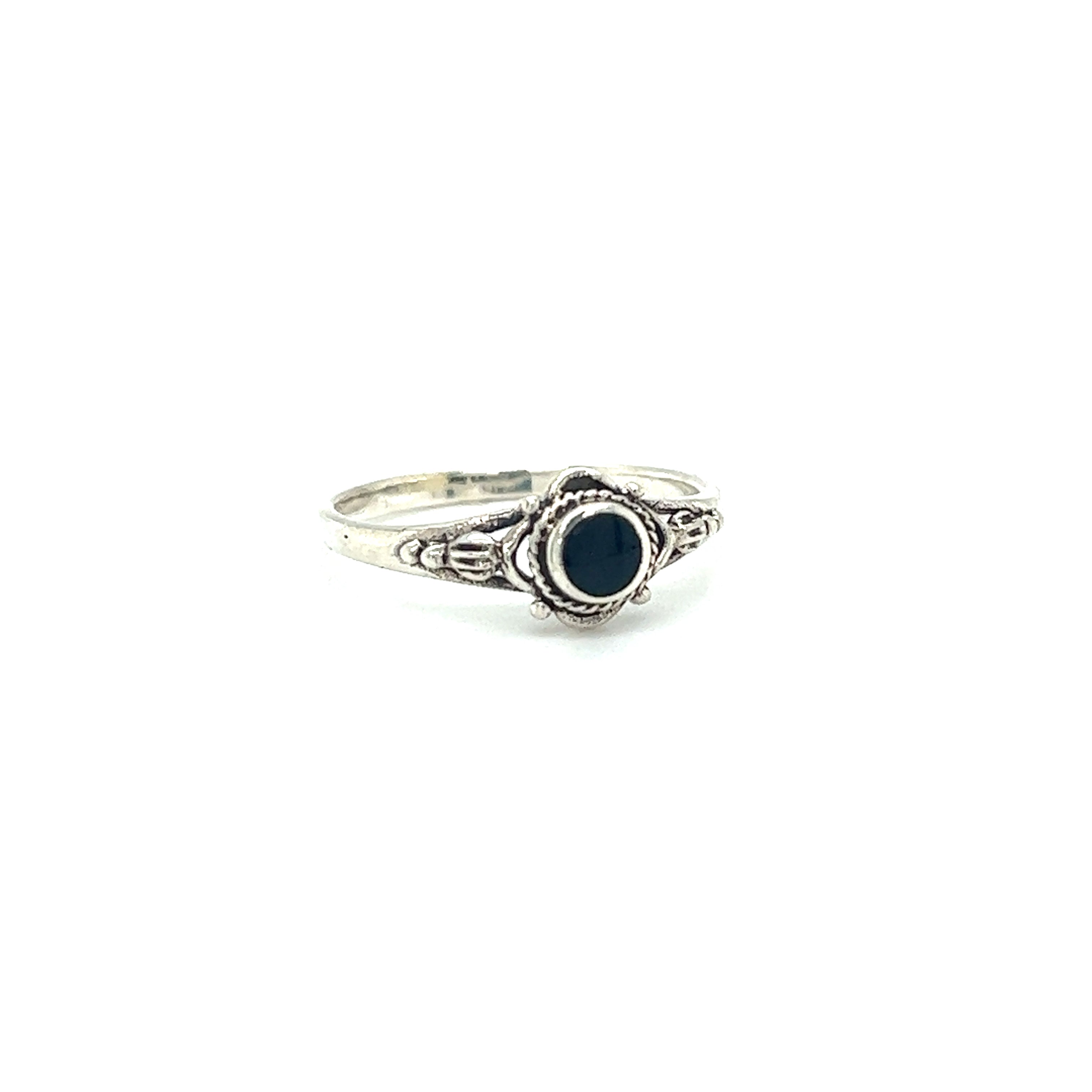 A Super Silver Dainty Inlaid Stone Ring with Subtle Flower Setting, with a captivating allure, featuring a tiny inlaid black stone.