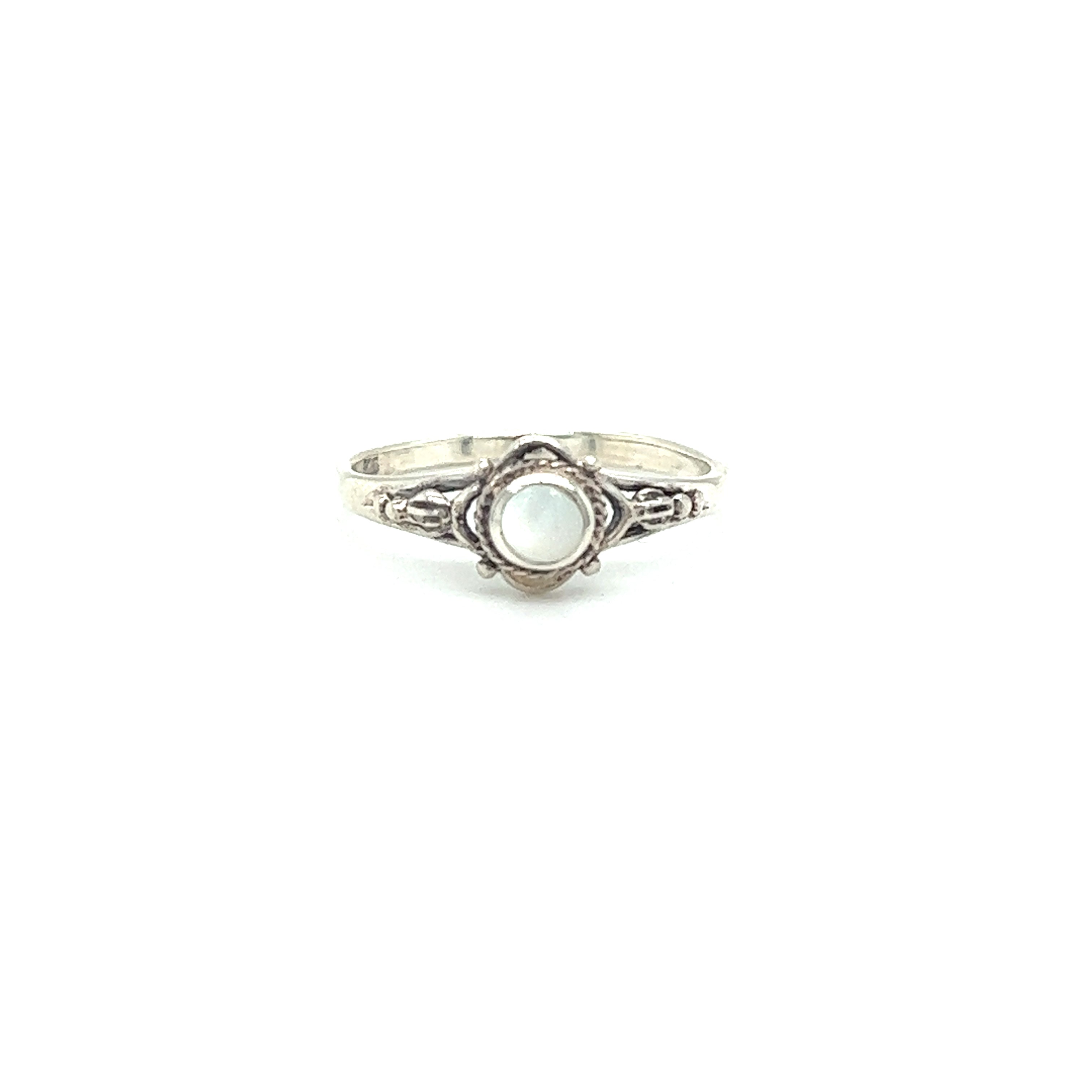 A captivating Super Silver ring adorned with a tiny mother of pearl stone, showcasing a Bali-style aesthetic.