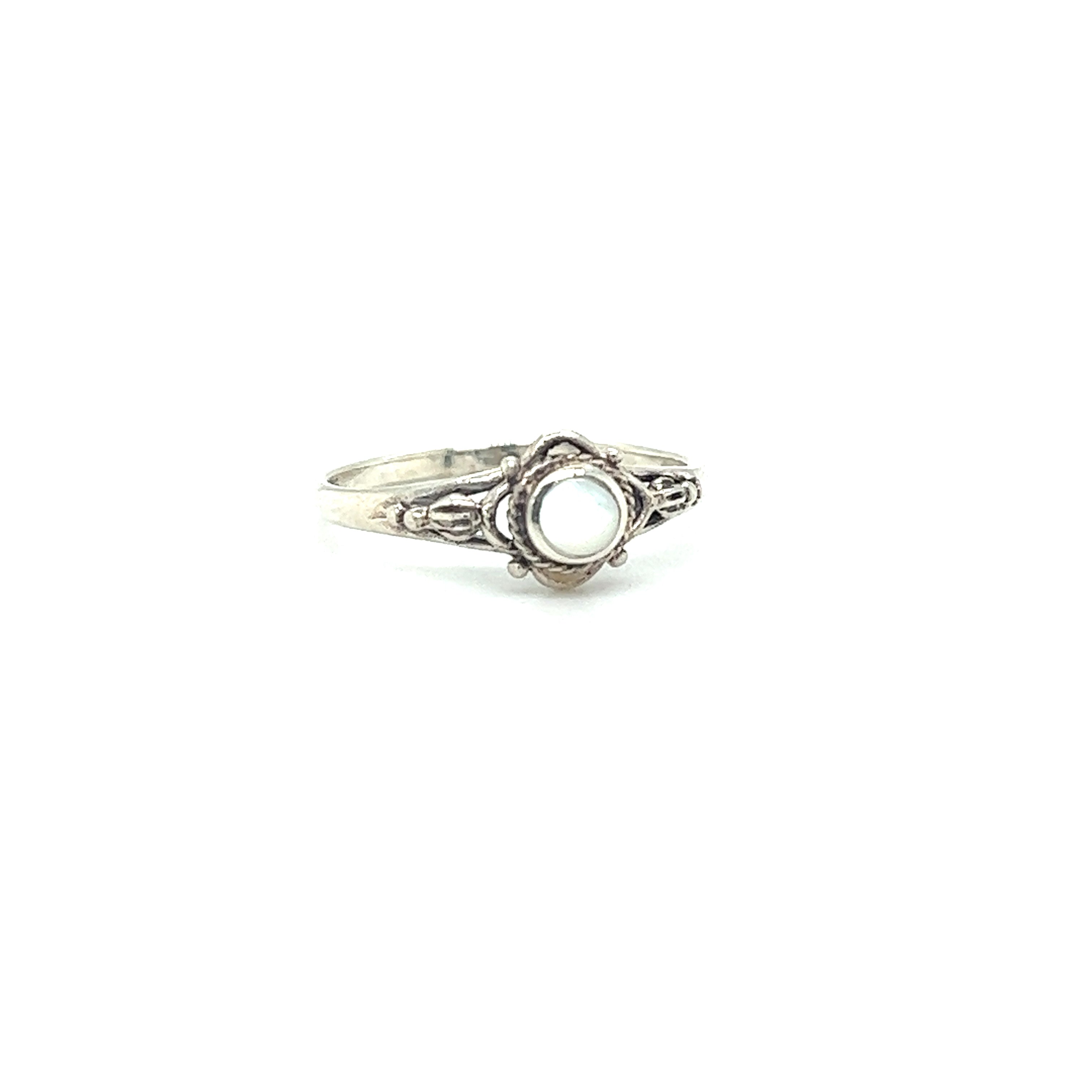 A Super Silver Dainty Inlaid Stone Ring with Subtle Flower Setting with captivating allure on a white background.