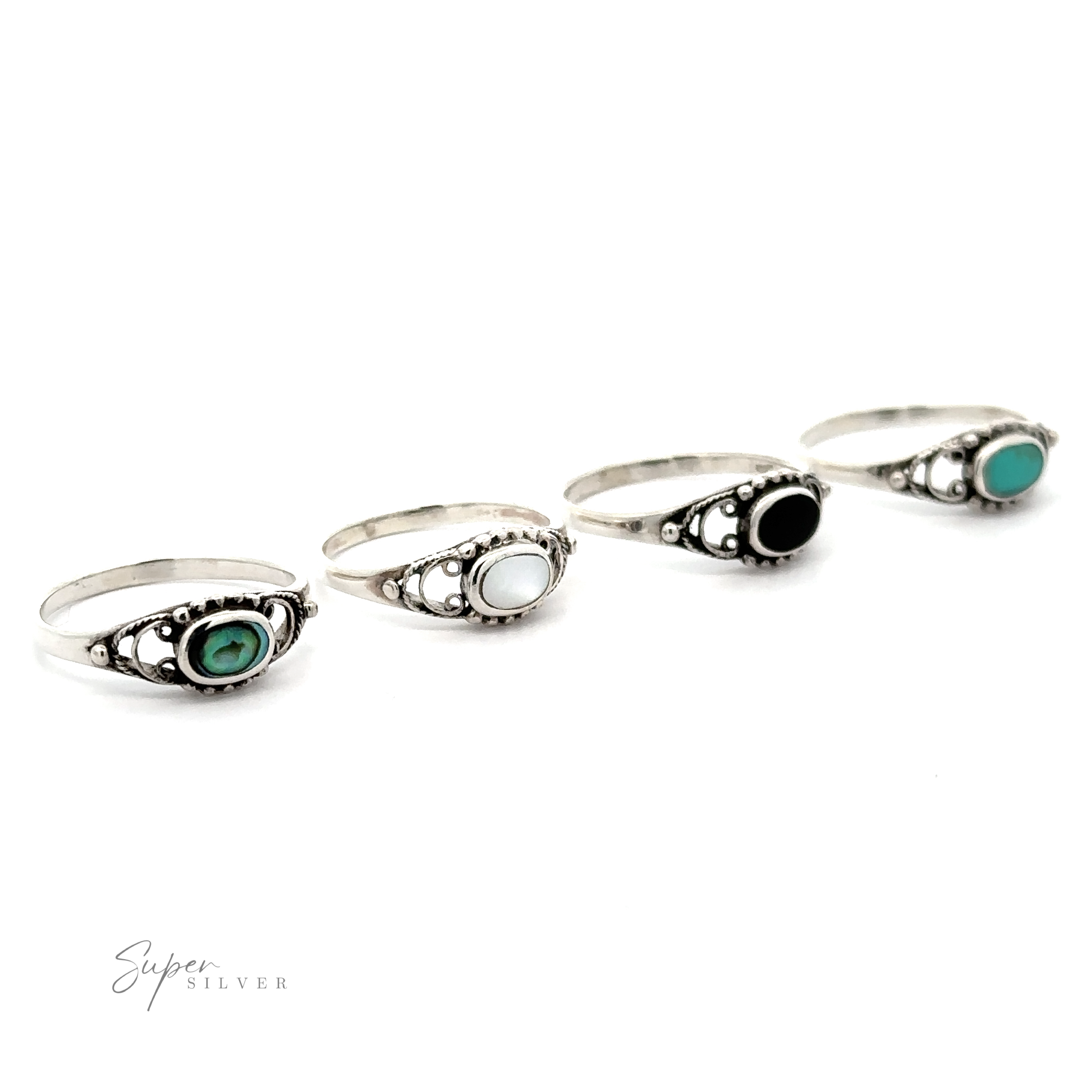 Four sterling silver rings with green and black stones, including an oval stone ring with a delicate border.