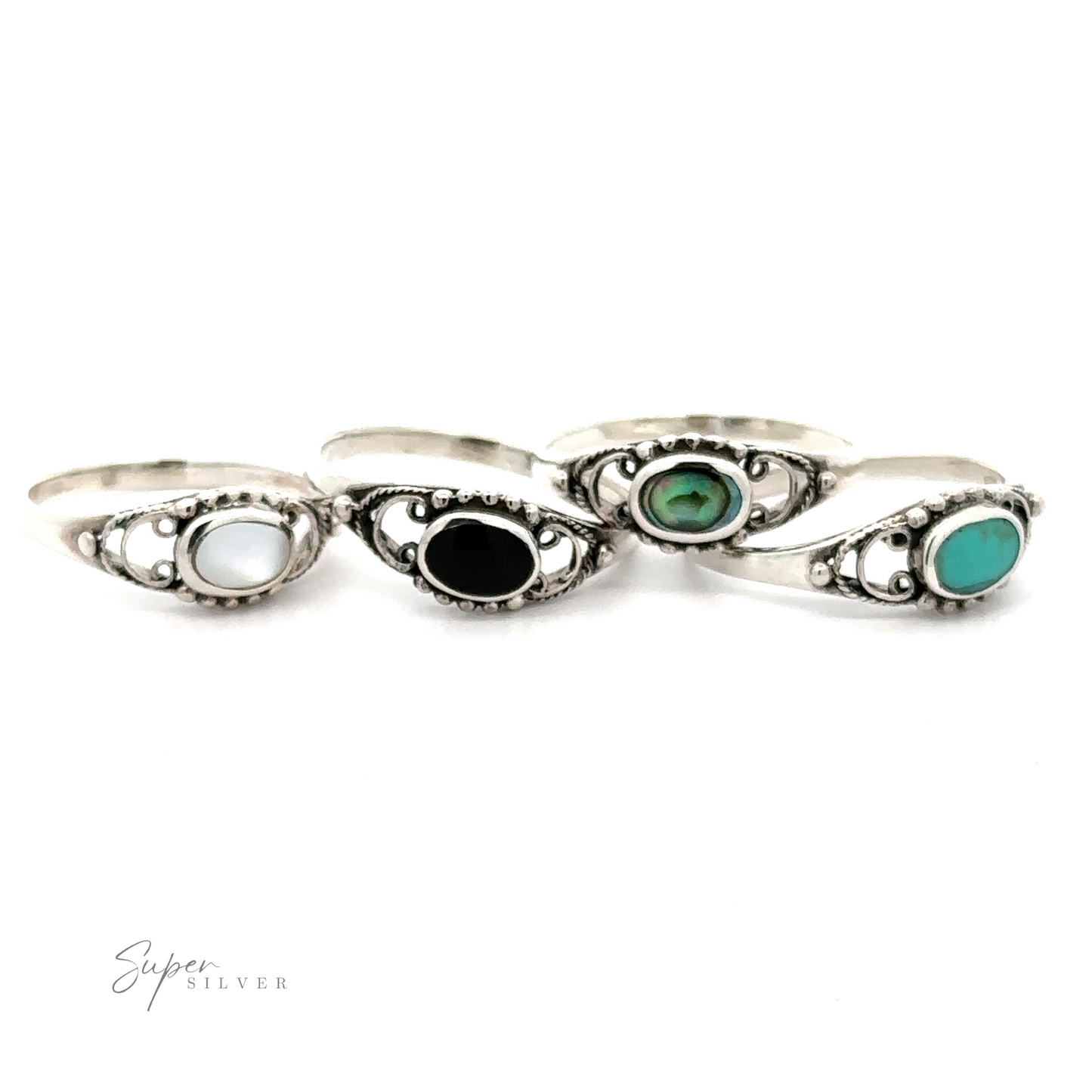 Four Oval Stone Rings With Delicate Border in a ball pattern that includes black and green stones.