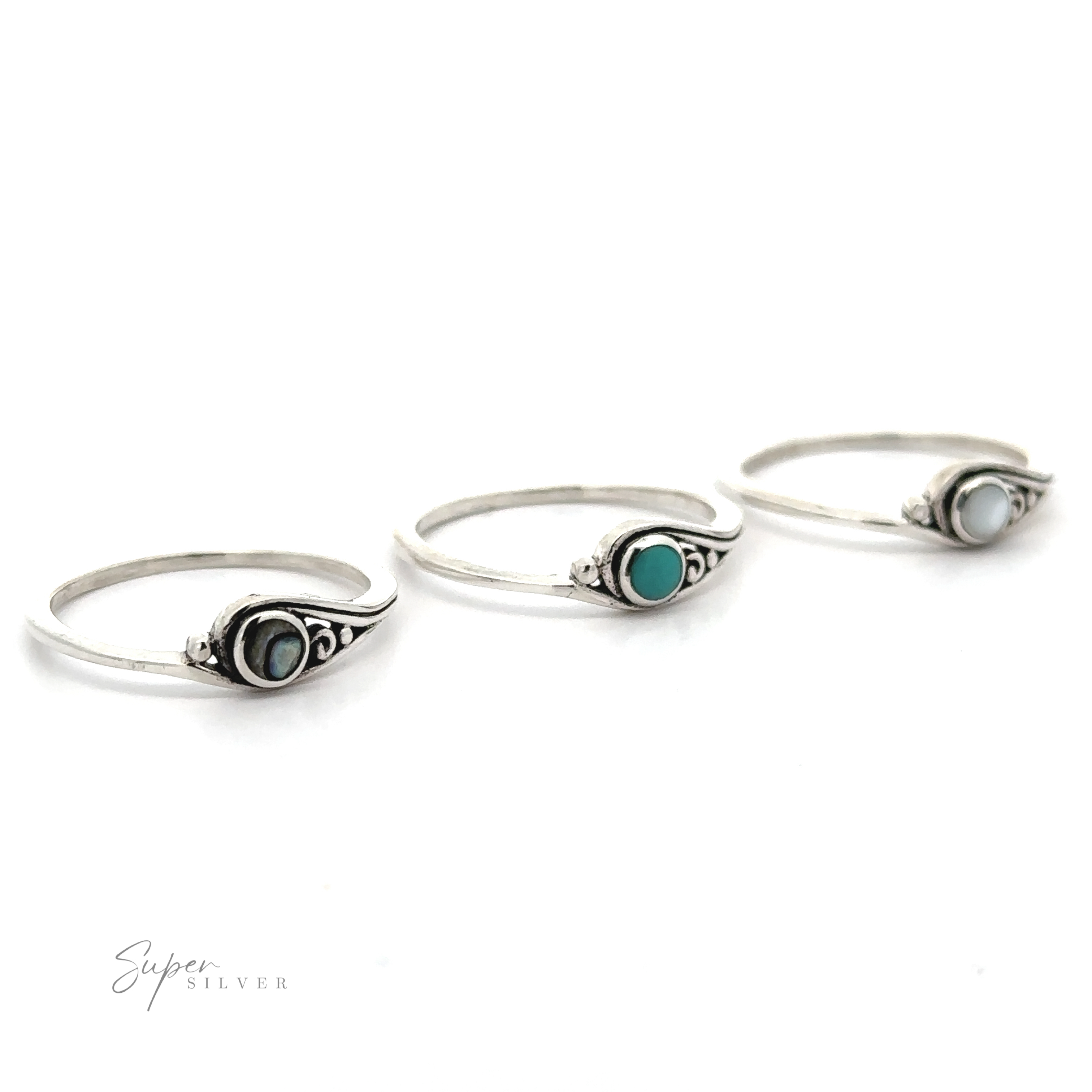 Three delicate inlay stone rings with small swirl design.